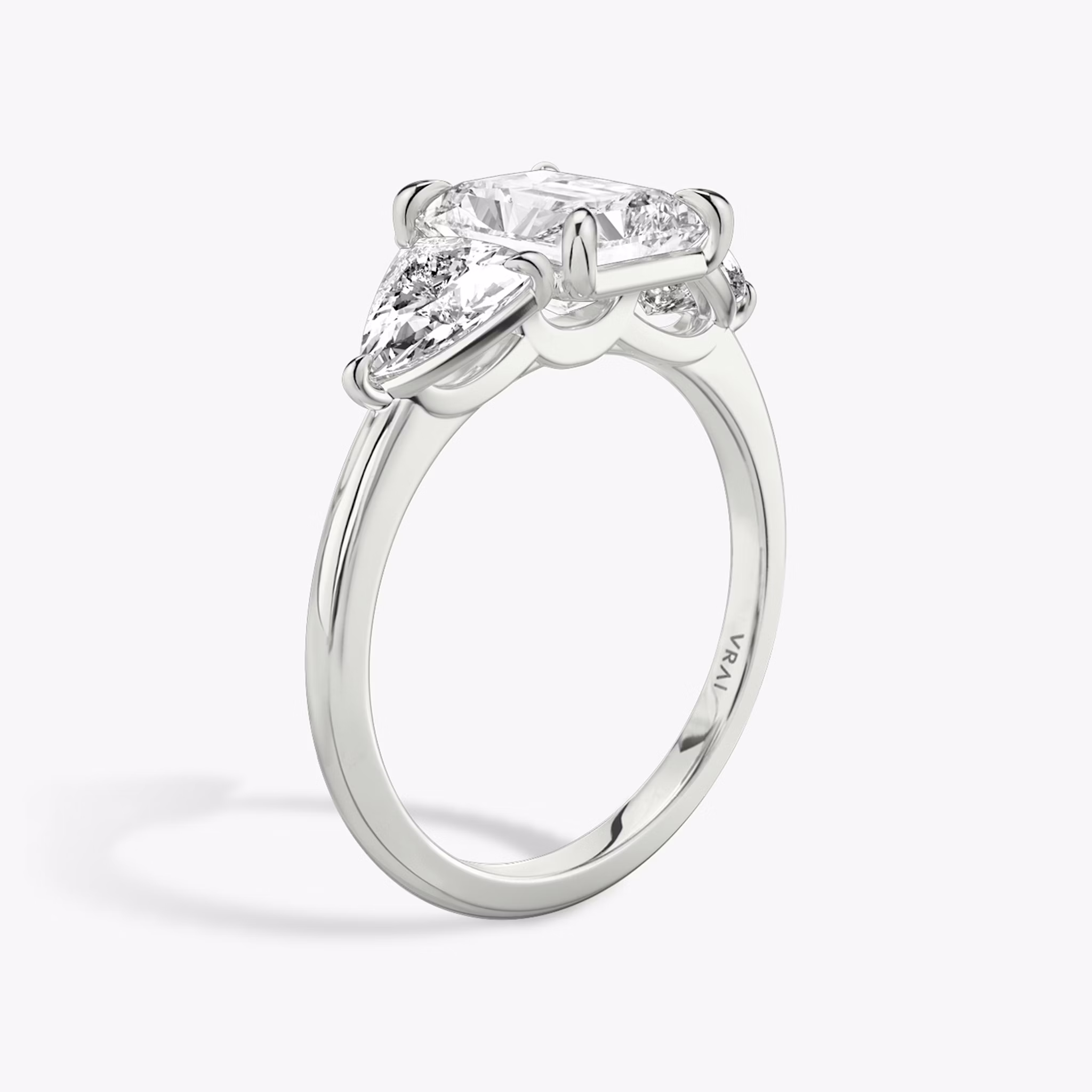 The Three Stone | Radiant | Platinum | bandAccent: Plain | sideStoneCarat: 0.50ct | sideStoneShape: Trillion | diamondOrientation: vertical | caratWeight: other