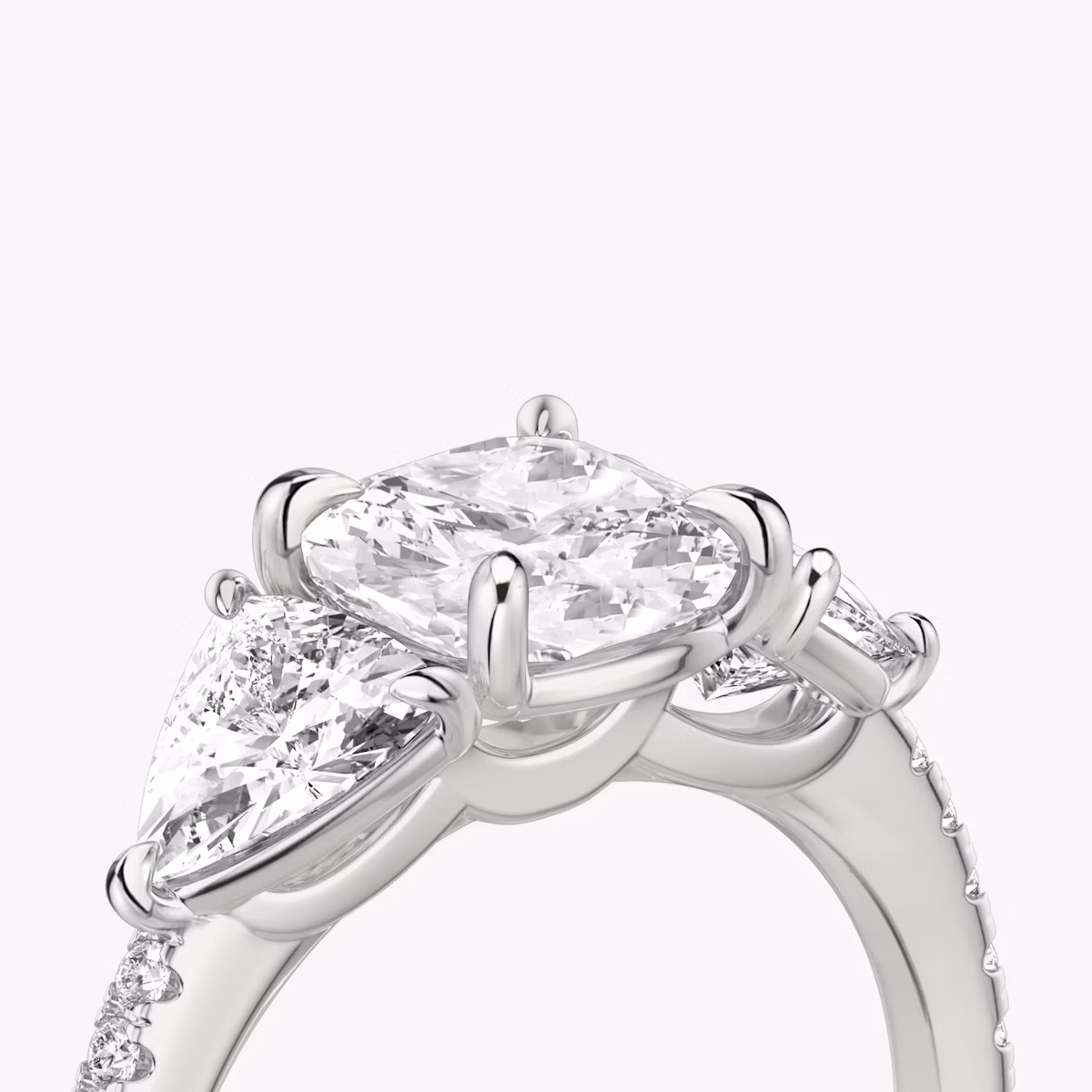The Three Stone | Cushion | Platinum | bandAccent: Pavé | sideStoneCarat: 0.50ct | sideStoneShape: Trillion | diamondOrientation: vertical | caratWeight: other