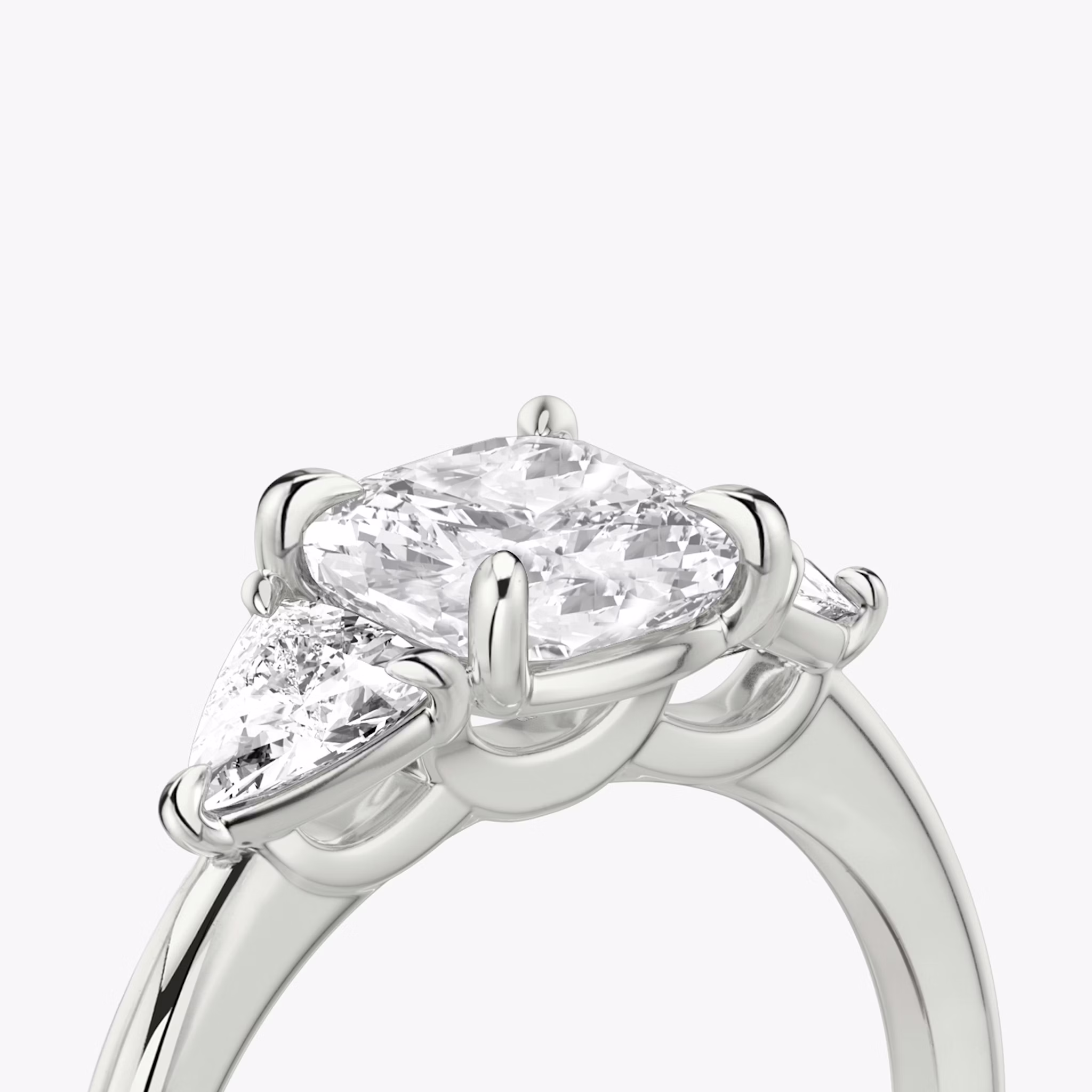 The Three Stone | Cushion | Platinum | bandAccent: Plain | sideStoneCarat: 0.25ct | sideStoneShape: Trillion | diamondOrientation: vertical | caratWeight: other