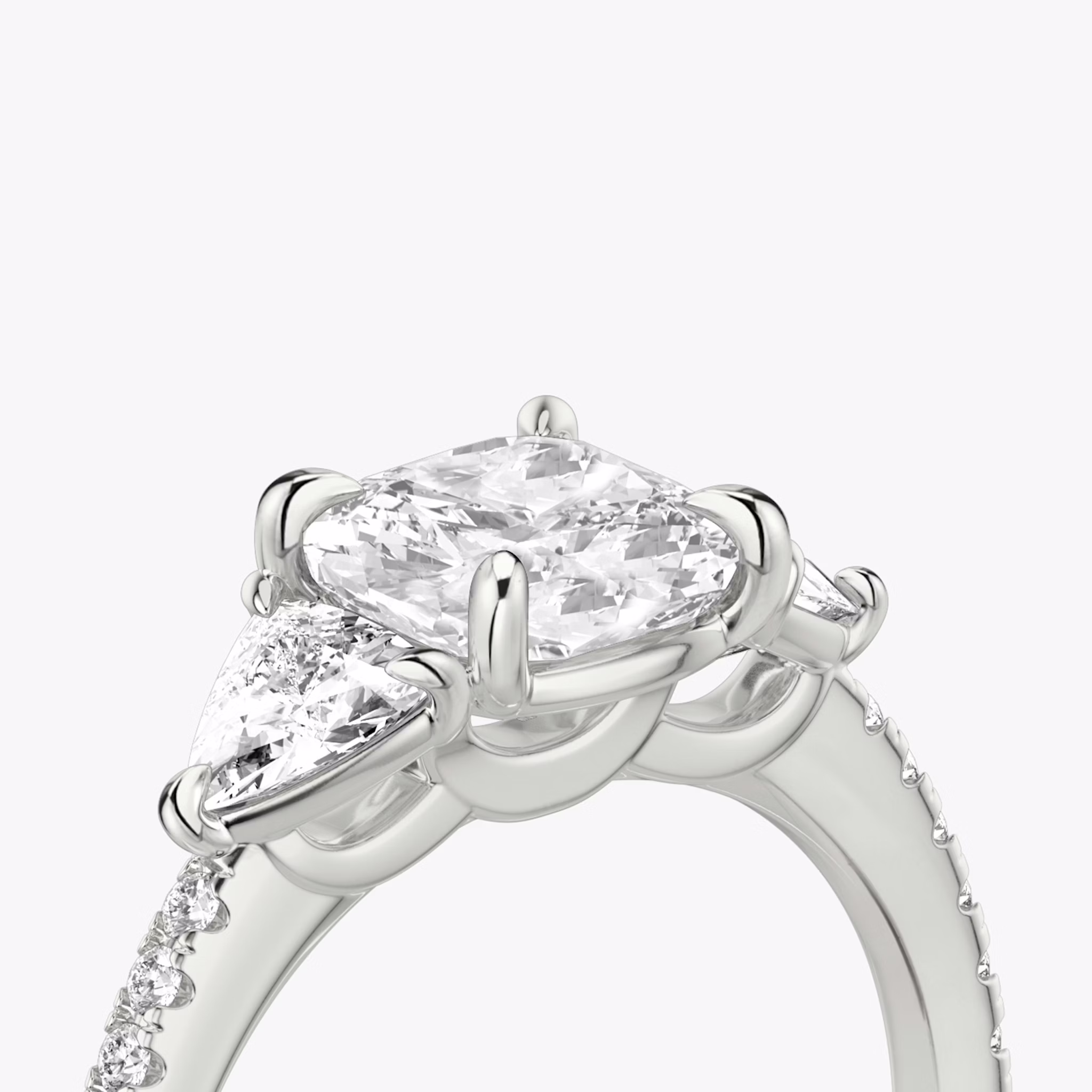 The Three Stone | Cushion | Platinum | bandAccent: Pavé | sideStoneCarat: 0.25ct | sideStoneShape: Trillion | diamondOrientation: vertical | caratWeight: other