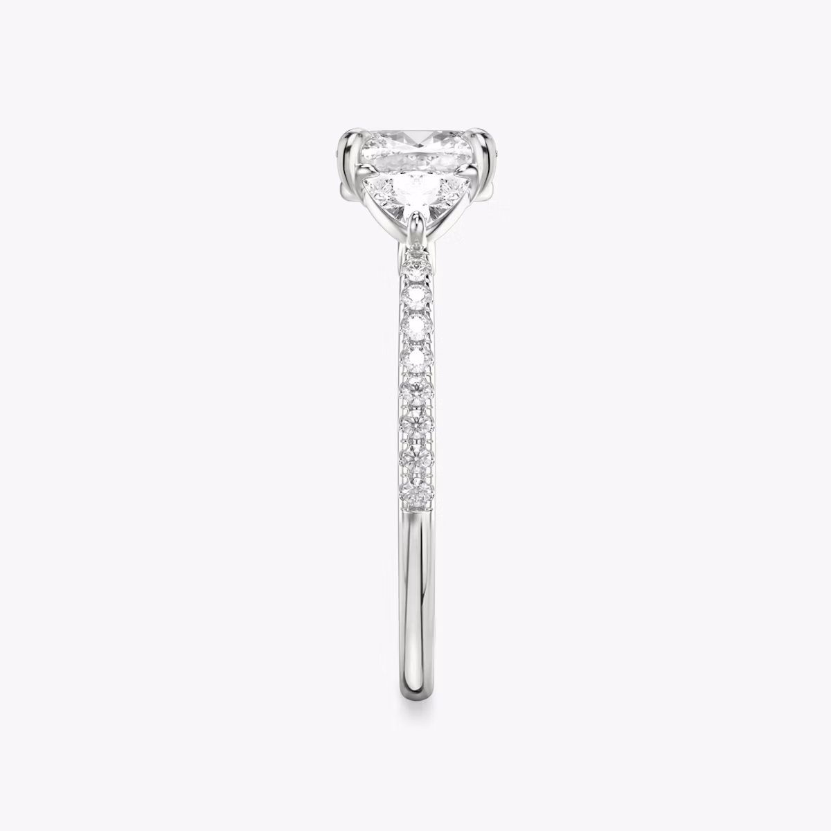 Anillo de compromiso Three Stone | Cojín | Platino | bandAccent: Pavé | sideStoneCarat: 0.25ct | sideStoneShape: Trillón | diamondOrientation: vertical | caratWeight: other