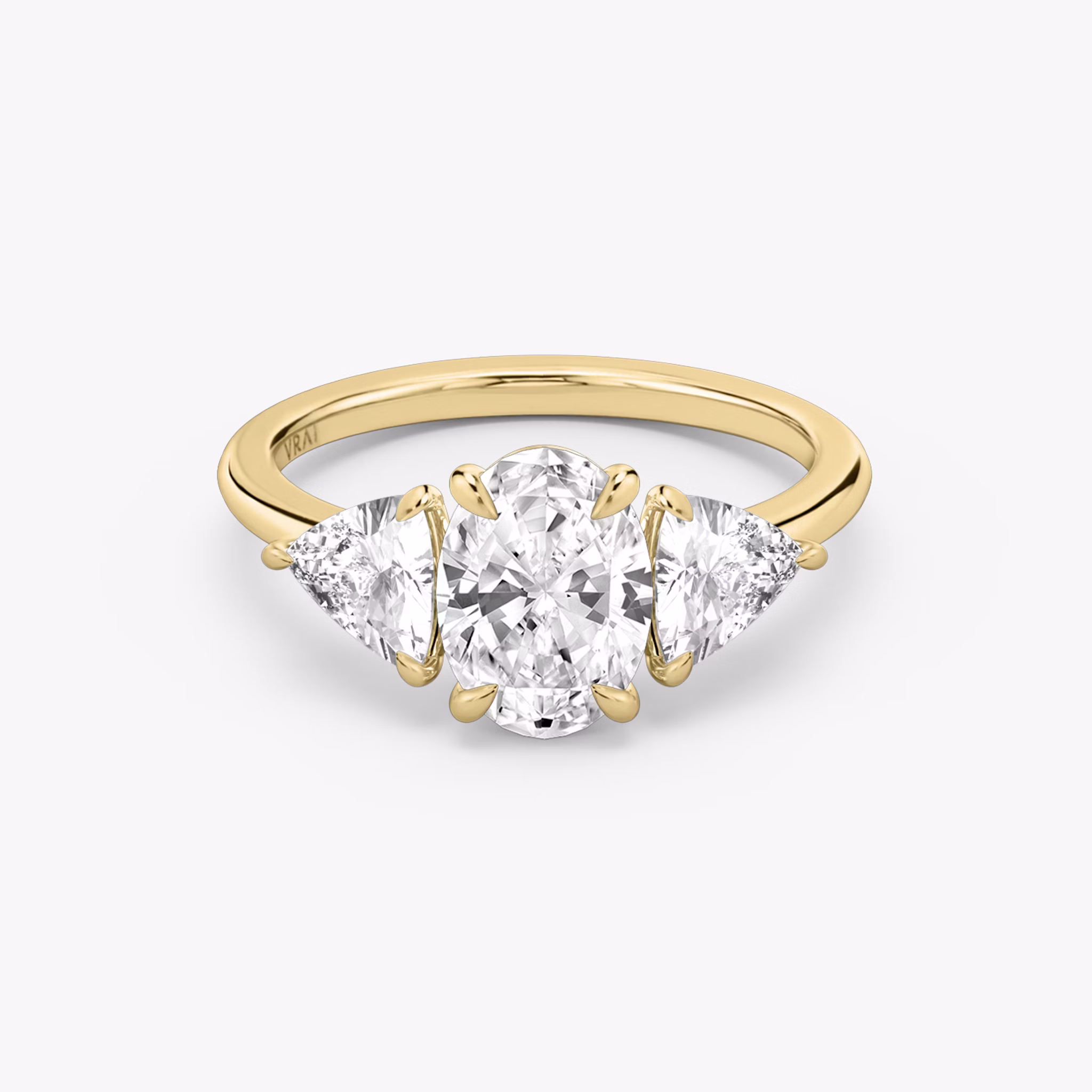 The Three Stone | Oval | 18k | Yellow Gold | bandAccent: Plain | sideStoneCarat: 0.50ct | sideStoneShape: Trillion | diamondOrientation: vertical | caratWeight: other