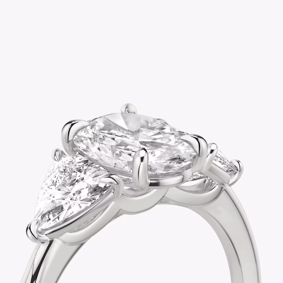 The Three Stone | Oval | 18k | White Gold | bandAccent: Plain | sideStoneCarat: 0.50ct | sideStoneShape: Trillion | diamondOrientation: vertical | caratWeight: other