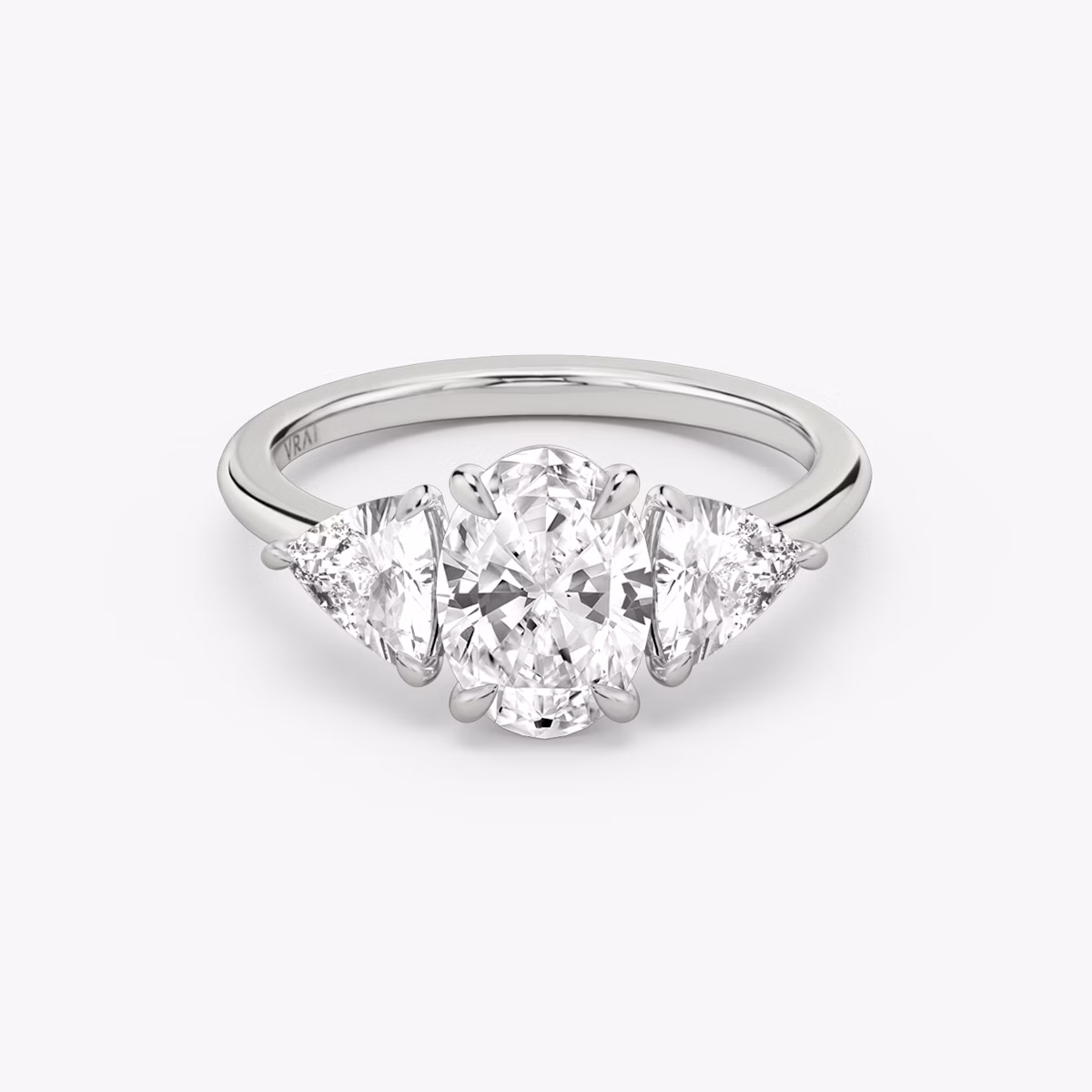 The Three Stone | Oval | 18k | White Gold | bandAccent: Plain | sideStoneCarat: 0.50ct | sideStoneShape: Trillion | diamondOrientation: vertical | caratWeight: other