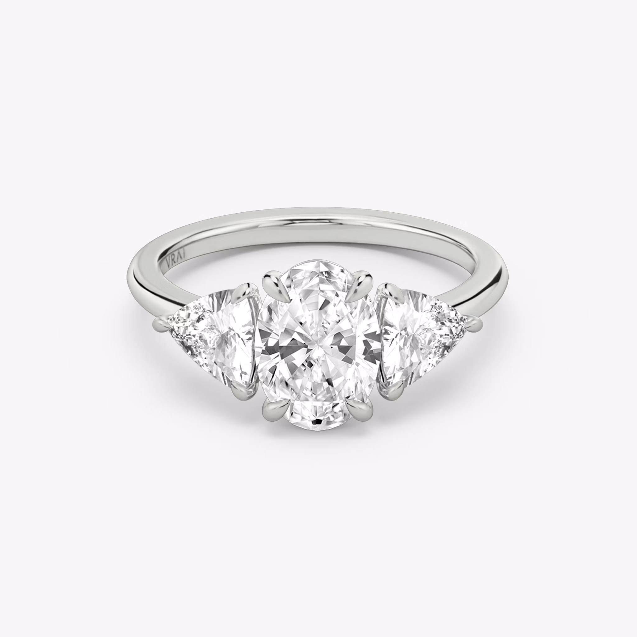 The Three Stone | Oval | 18k | White Gold | bandAccent: Plain | sideStoneCarat: 0.50ct | sideStoneShape: Trillion | diamondOrientation: vertical | caratWeight: other