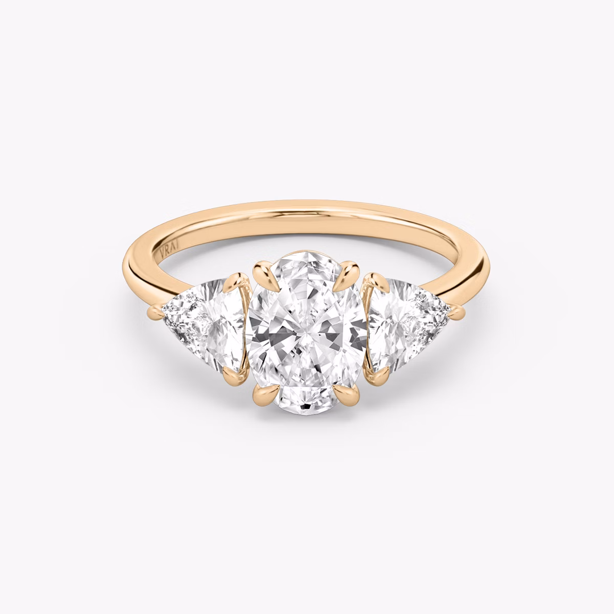 The Three Stone | Oval | 14k | Rose Gold | bandAccent: Plain | sideStoneCarat: 0.50ct | sideStoneShape: Trillion | diamondOrientation: vertical | caratWeight: other