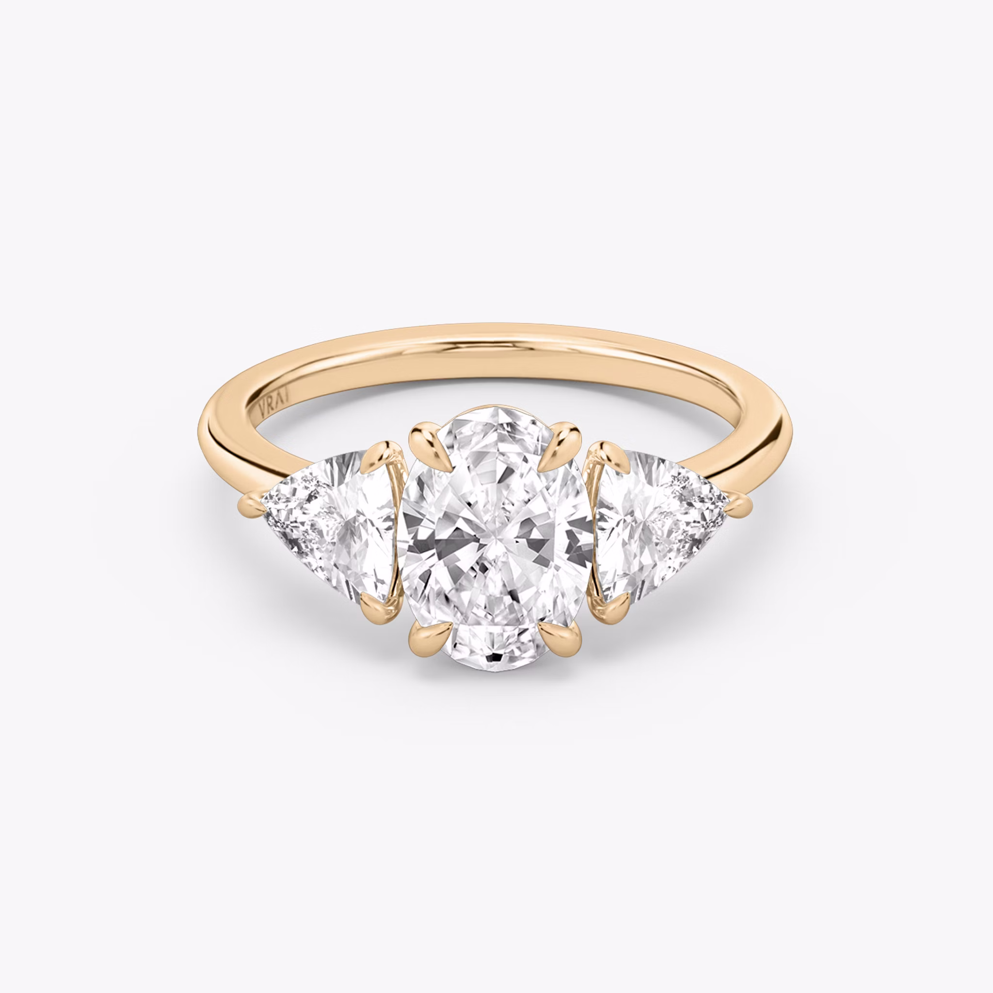 The Three Stone | Oval | 14k | Rose Gold | bandAccent: Plain | sideStoneCarat: 0.50ct | sideStoneShape: Trillion | diamondOrientation: vertical | caratWeight: other