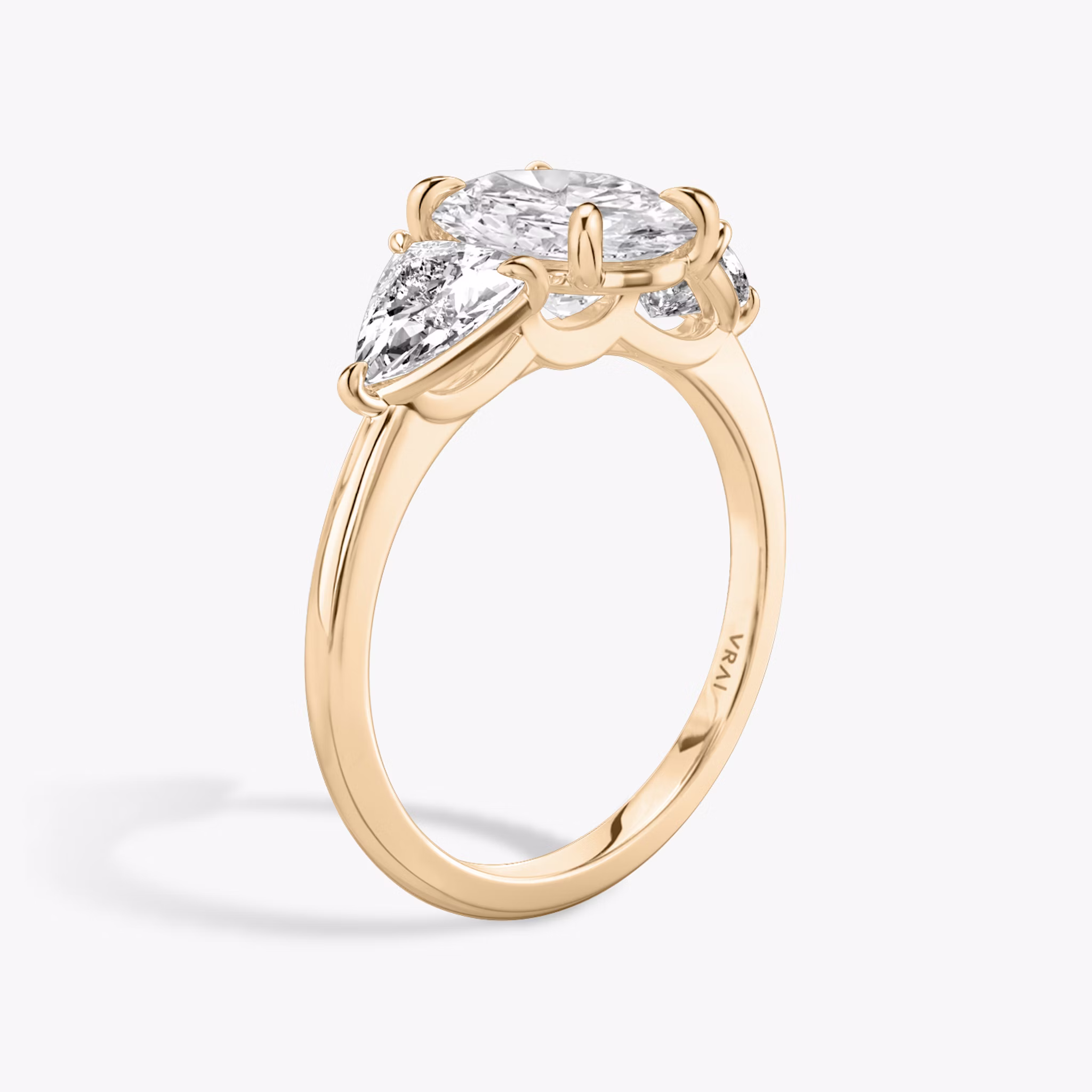 The Three Stone | Oval | 14k | Rose Gold | bandAccent: Plain | sideStoneCarat: 0.50ct | sideStoneShape: Trillion | diamondOrientation: vertical | caratWeight: other