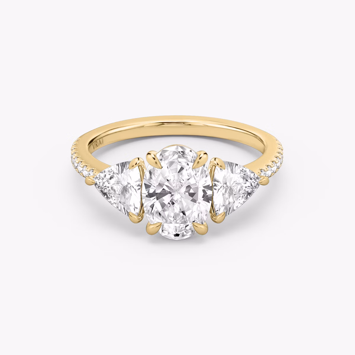 The Three Stone | Oval | 18k | Yellow Gold | bandAccent: Pavé | sideStoneCarat: 0.50ct | sideStoneShape: Trillion | diamondOrientation: vertical | caratWeight: other