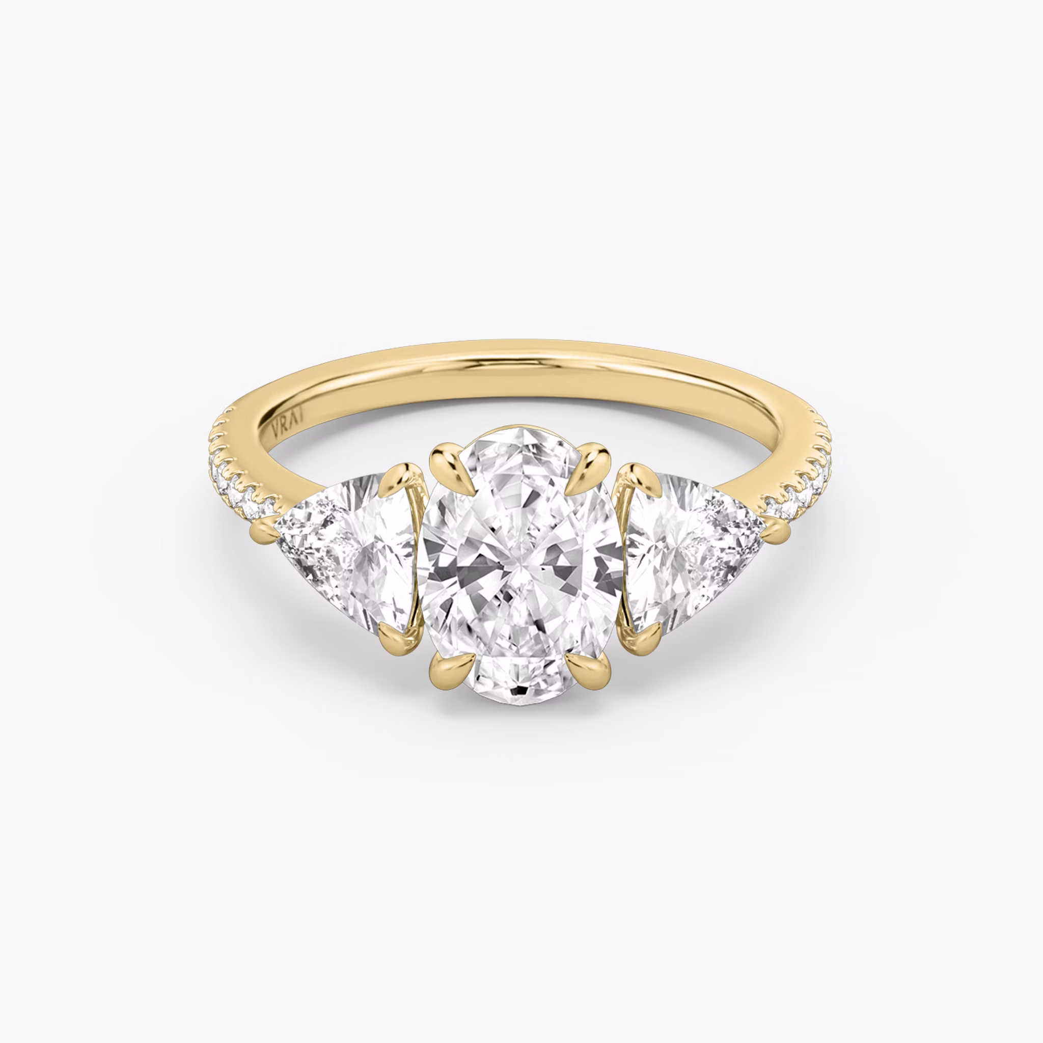 The Three Stone | Oval | 18k | Yellow Gold | bandAccent: Pavé | sideStoneCarat: 0.50ct | sideStoneShape: Trillion | diamondOrientation: vertical | caratWeight: other