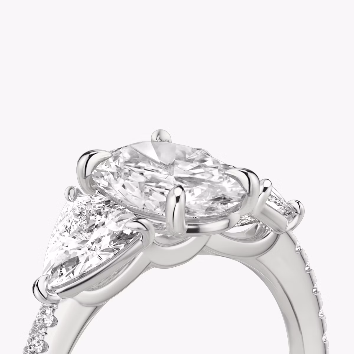 The Three Stone | Oval | 18k | White Gold | bandAccent: Pavé | sideStoneCarat: 0.50ct | sideStoneShape: Trillion | diamondOrientation: vertical | caratWeight: other