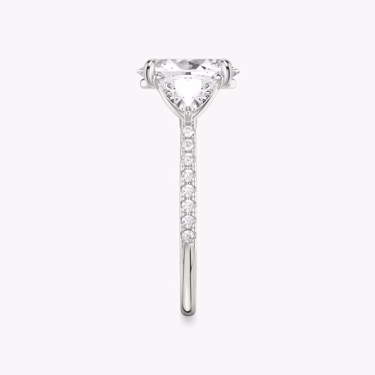 The Three Stone | Oval | 18k | White Gold | bandAccent: Pavé | sideStoneCarat: 0.50ct | sideStoneShape: Trillion | diamondOrientation: vertical | caratWeight: other