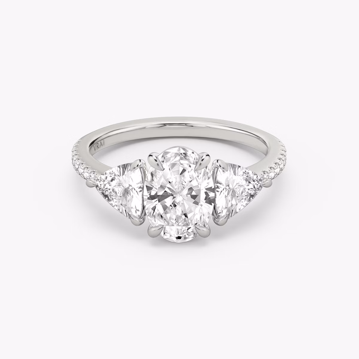 The Three Stone | Oval | Platinum | bandAccent: Pavé | sideStoneCarat: 0.50ct | sideStoneShape: Trillion | diamondOrientation: vertical | caratWeight: other