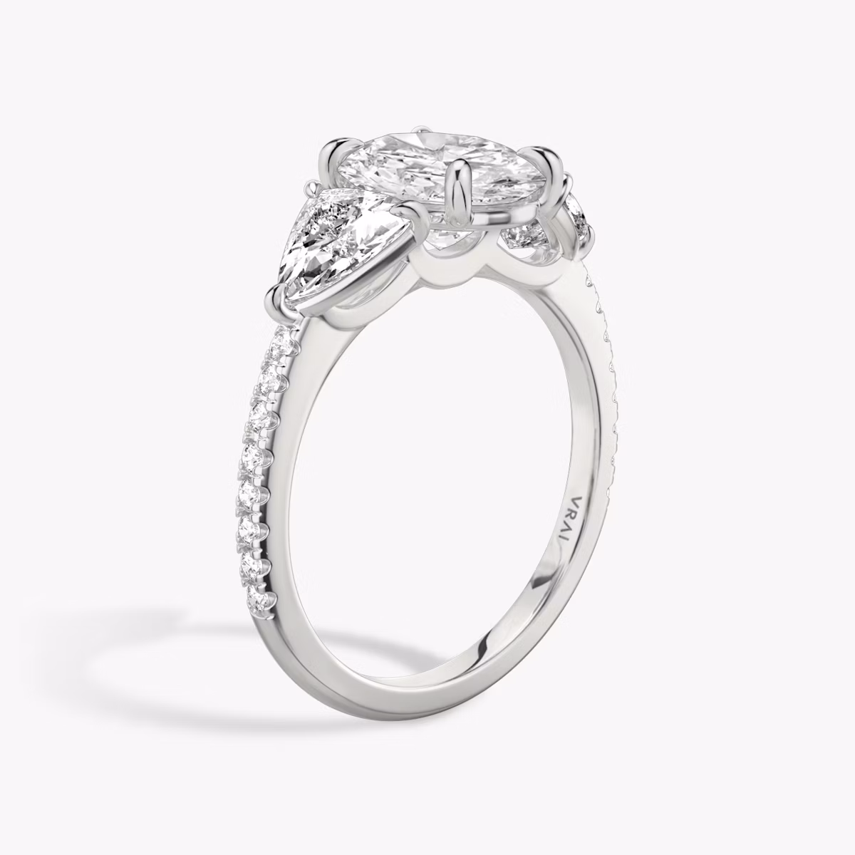The Three Stone | Oval | Platinum | bandAccent: Pavé | sideStoneCarat: 0.50ct | sideStoneShape: Trillion | diamondOrientation: vertical | caratWeight: other