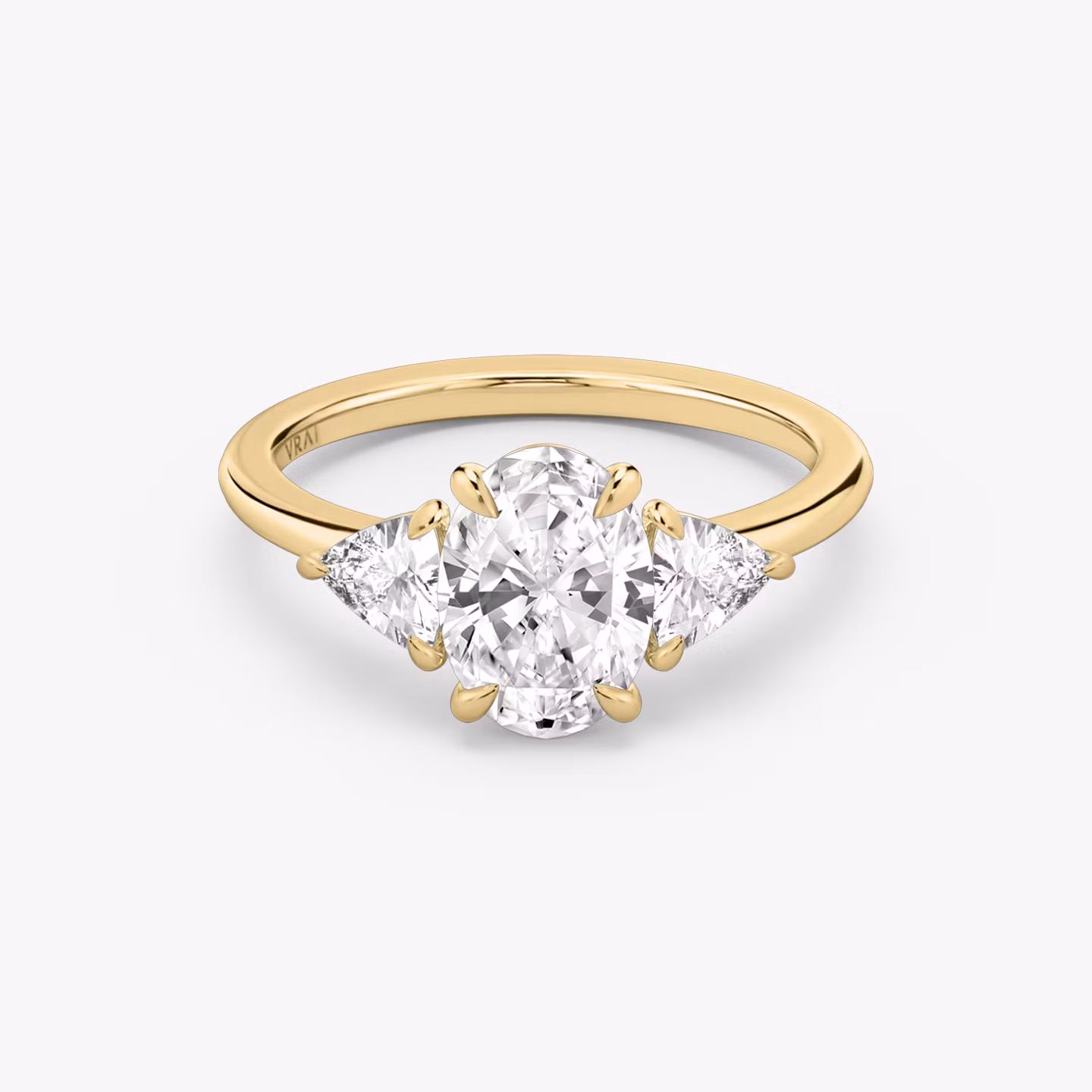 The Three Stone | Oval | 18k | Yellow Gold | bandAccent: Plain | sideStoneCarat: 0.25ct | sideStoneShape: Trillion | diamondOrientation: vertical | caratWeight: other