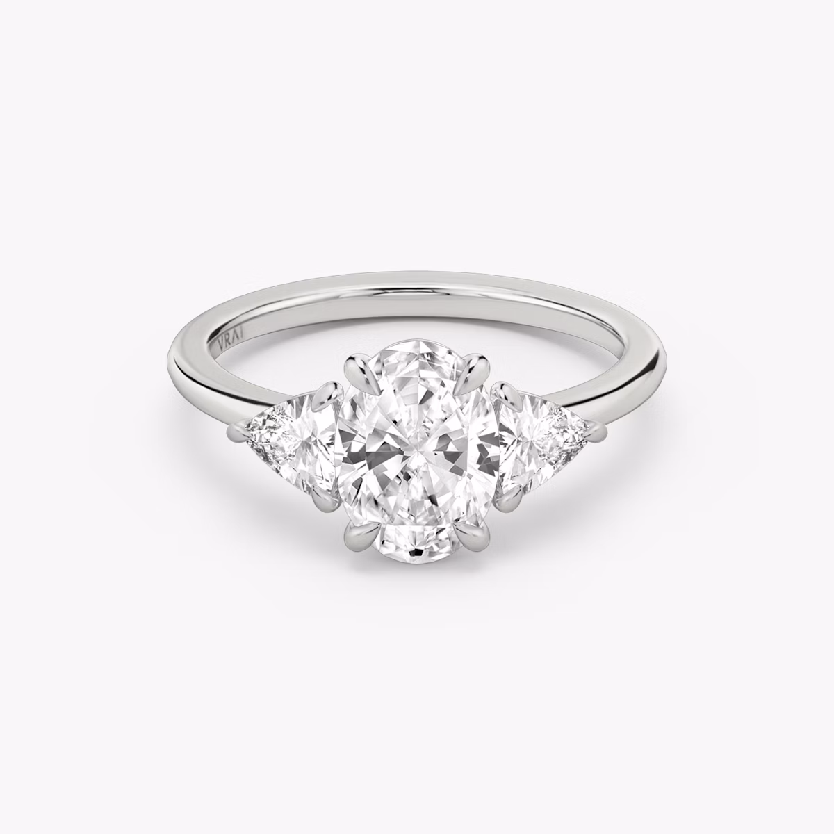 The Three Stone | Oval | 18k | White Gold | bandAccent: Plain | sideStoneCarat: 0.25ct | sideStoneShape: Trillion | diamondOrientation: vertical | caratWeight: other