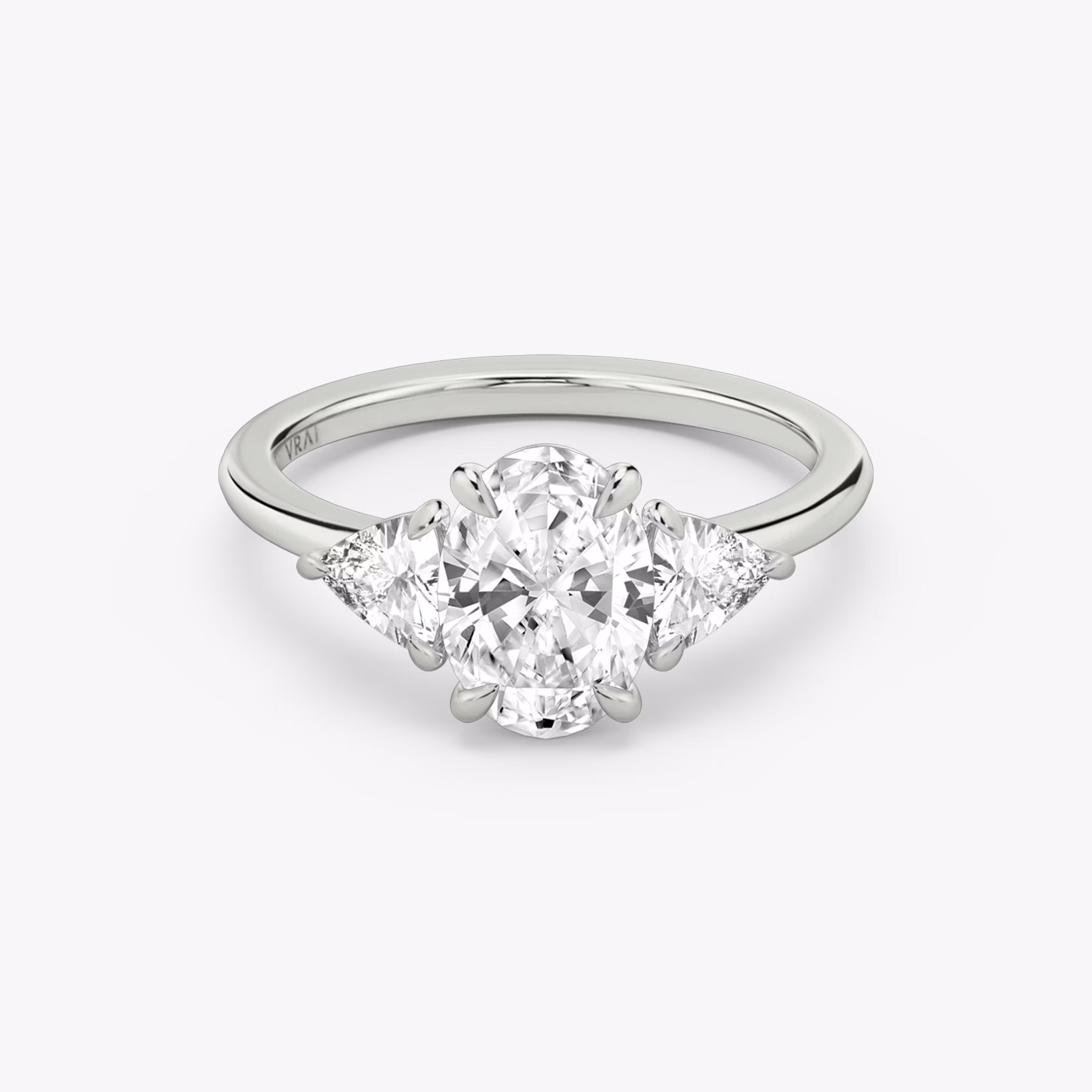 The Three Stone | Oval | 18k | White Gold | bandAccent: Plain | sideStoneCarat: 0.25ct | sideStoneShape: Trillion | diamondOrientation: vertical | caratWeight: other