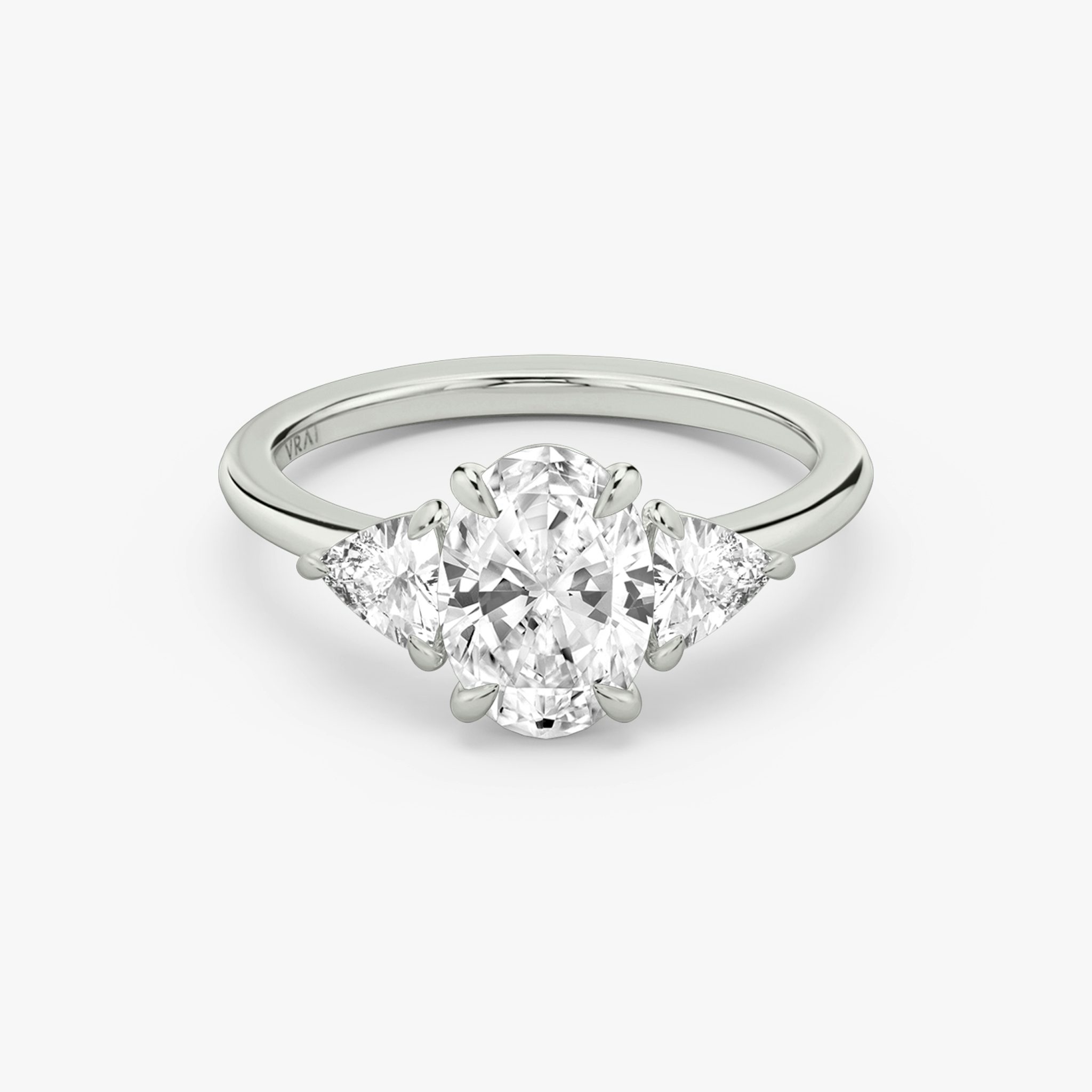 The Three Stone | Oval | 18k | White Gold | bandAccent: Plain | sideStoneCarat: 0.25ct | sideStoneShape: Trillion | diamondOrientation: vertical | caratWeight: other