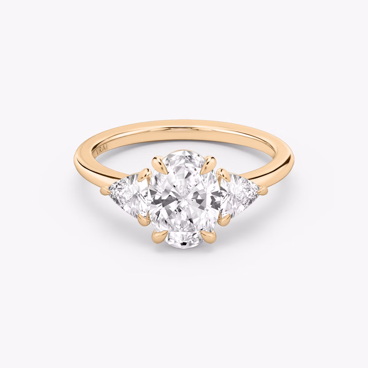 The Three Stone | Oval | 14k | Rose Gold | bandAccent: Plain | sideStoneCarat: 0.25ct | sideStoneShape: Trillion | diamondOrientation: vertical | caratWeight: other