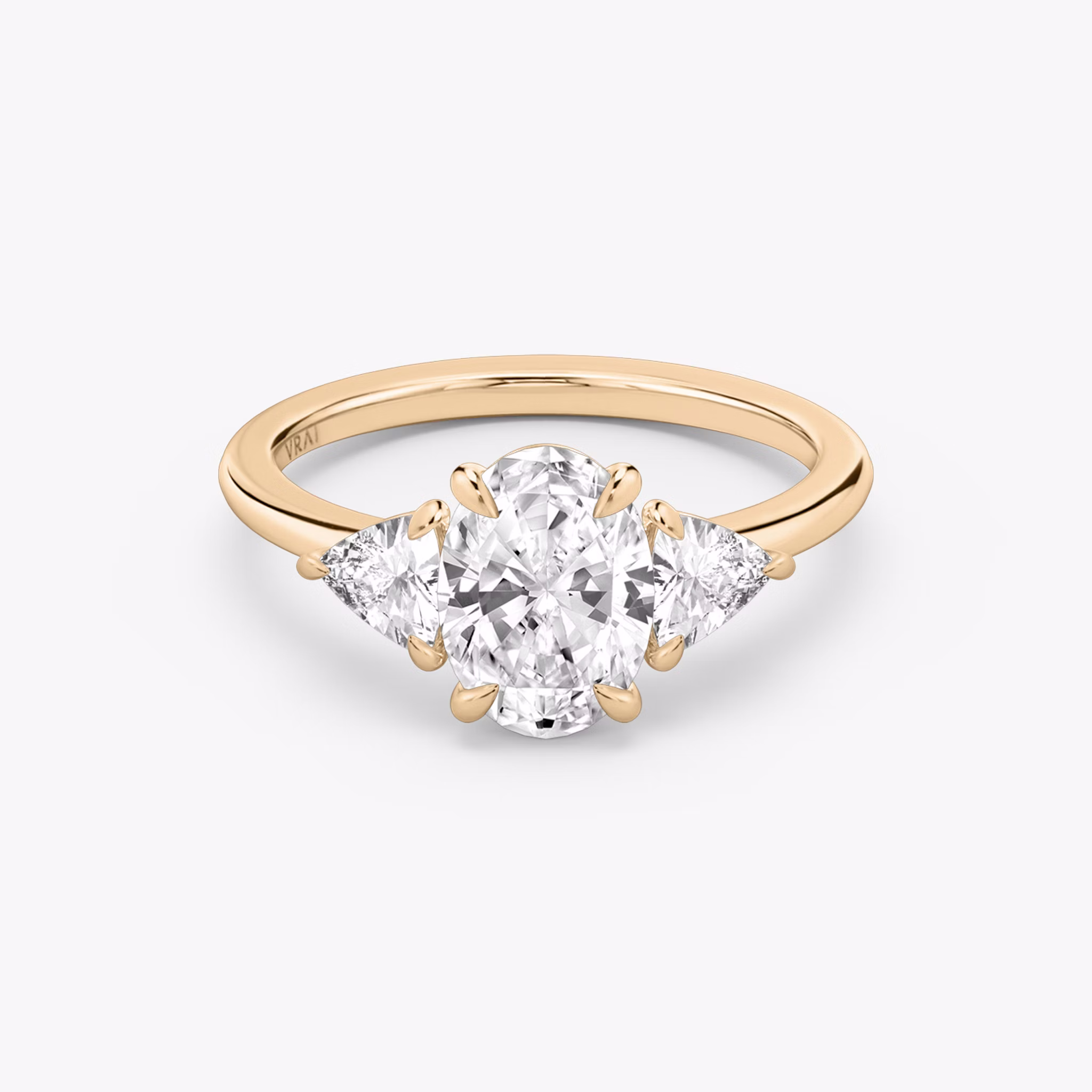 The Three Stone | Oval | 14k | Rose Gold | bandAccent: Plain | sideStoneCarat: 0.25ct | sideStoneShape: Trillion | diamondOrientation: vertical | caratWeight: other