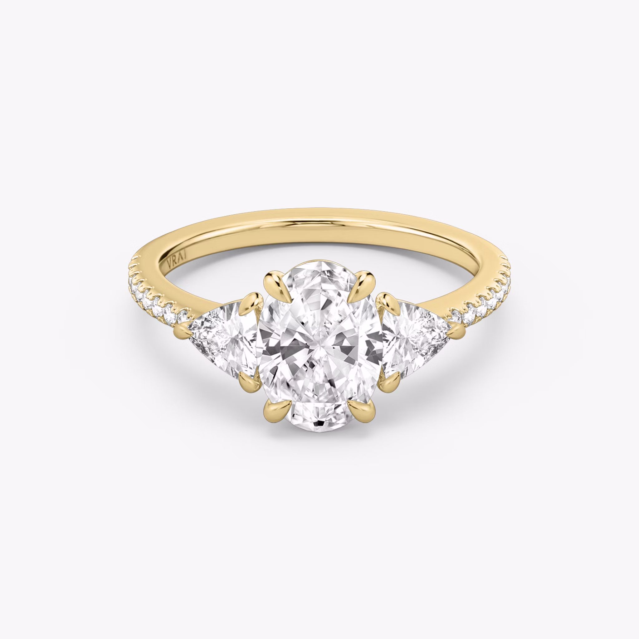 The Three Stone | Oval | 18k | Yellow Gold | bandAccent: Pavé | sideStoneCarat: 0.25ct | sideStoneShape: Trillion | diamondOrientation: vertical | caratWeight: other