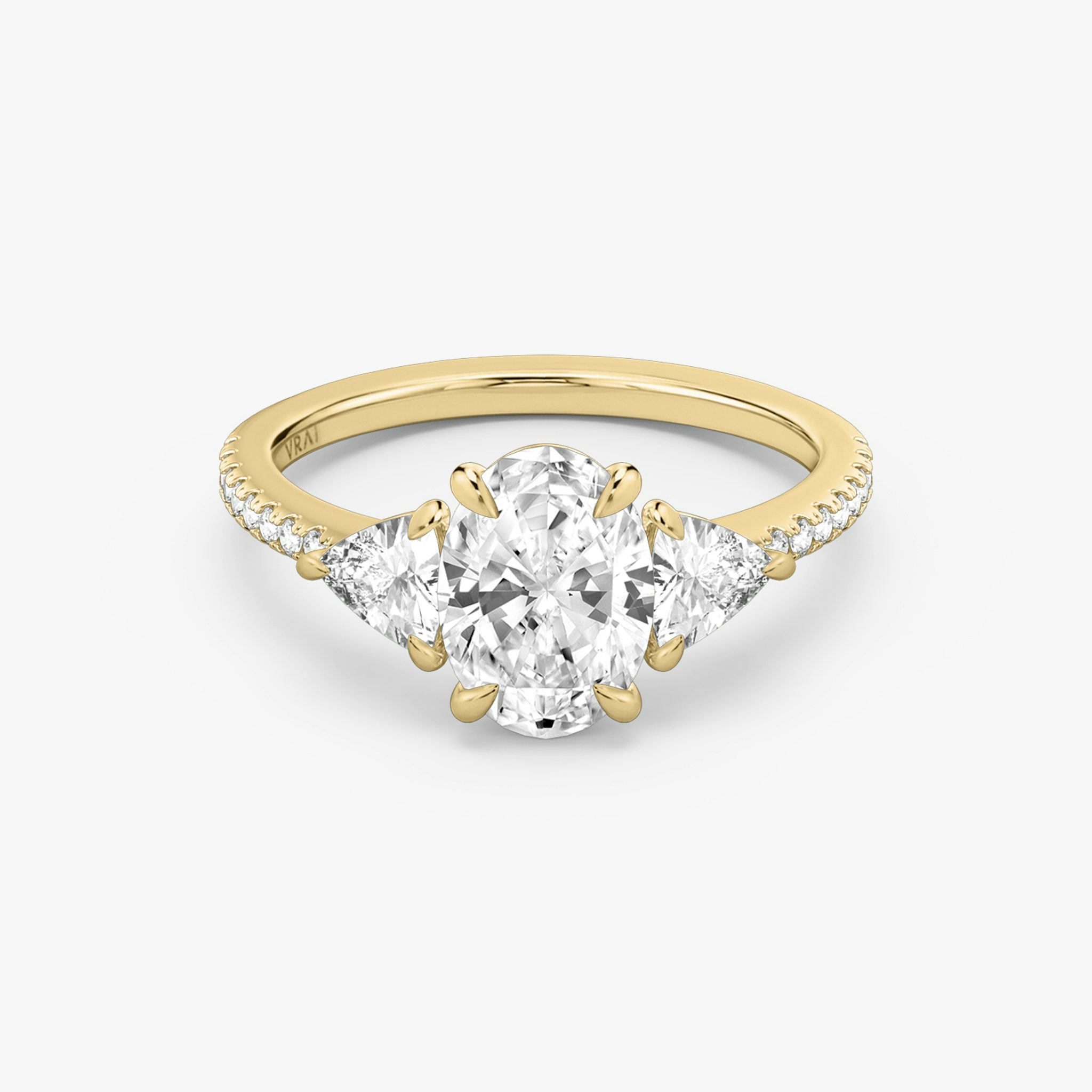 The Three Stone | Oval | 18k | Yellow Gold | bandAccent: Pavé | sideStoneCarat: 0.25ct | sideStoneShape: Trillion | diamondOrientation: vertical | caratWeight: other