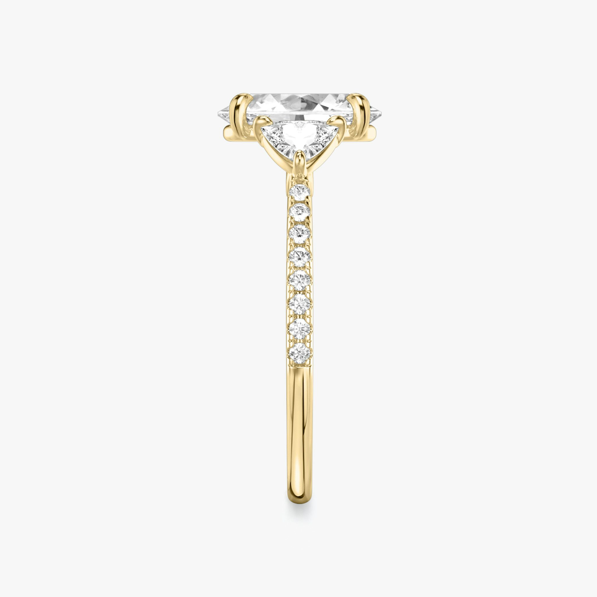 The Three Stone | Oval | 18k | Yellow Gold | bandAccent: Pavé | sideStoneCarat: 0.25ct | sideStoneShape: Trillion | diamondOrientation: vertical | caratWeight: other