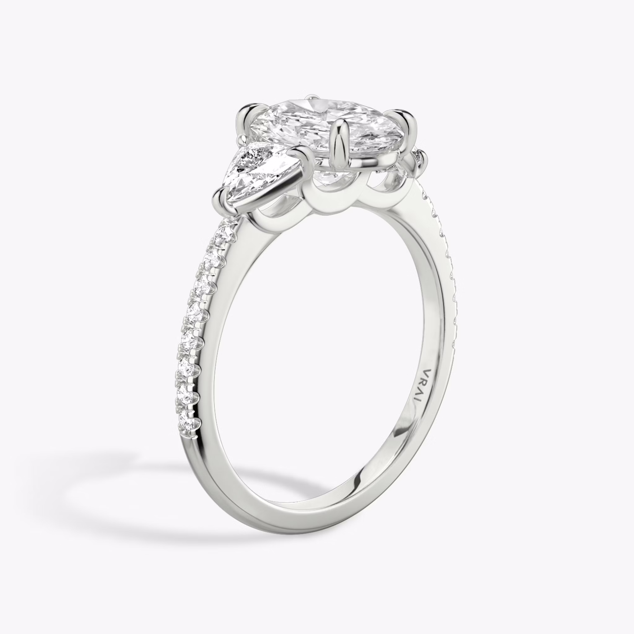 The Three Stone | Oval | 18k | White Gold | bandAccent: Pavé | sideStoneCarat: 0.25ct | sideStoneShape: Trillion | diamondOrientation: vertical | caratWeight: other