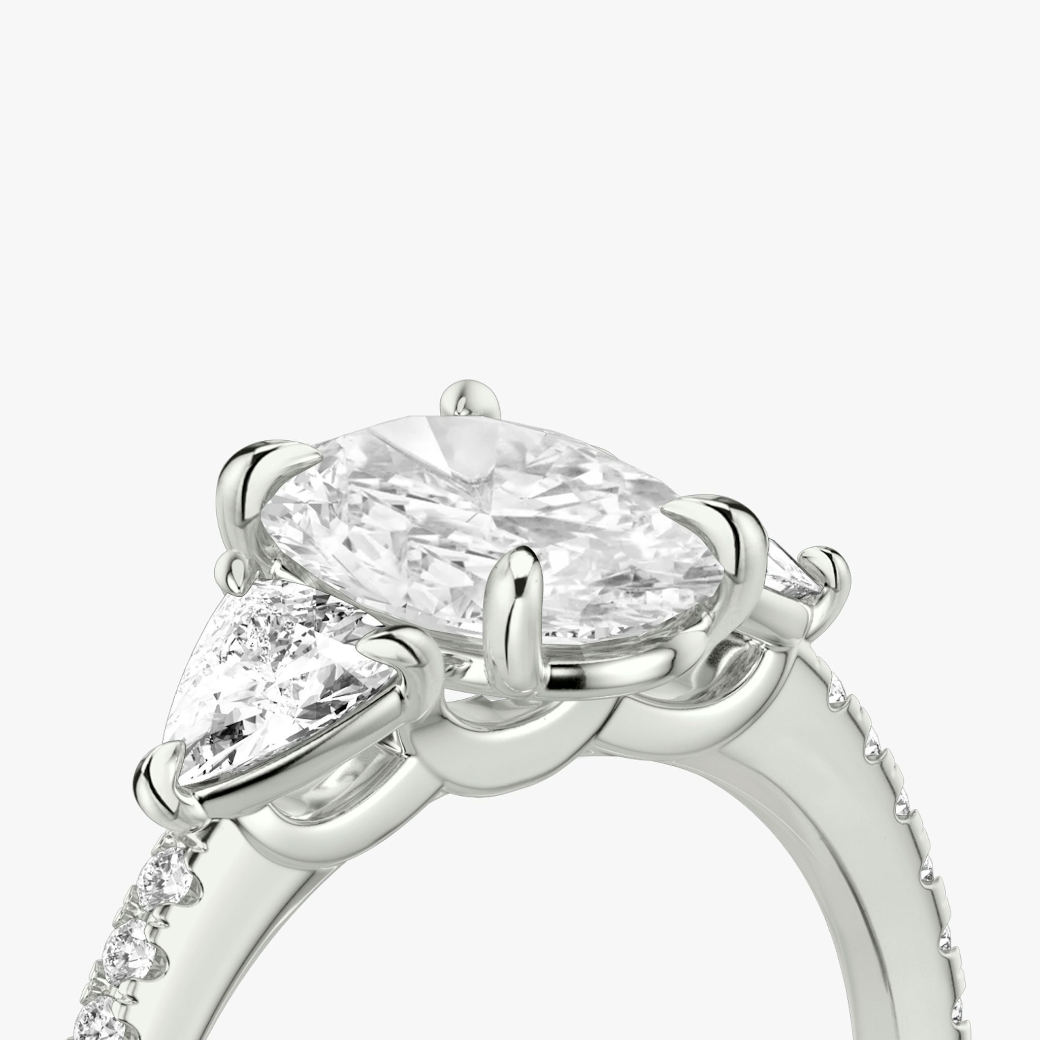 The Three Stone | Oval | Platinum | bandAccent: Pavé | sideStoneCarat: 0.25ct | sideStoneShape: Trillion | diamondOrientation: vertical | caratWeight: other