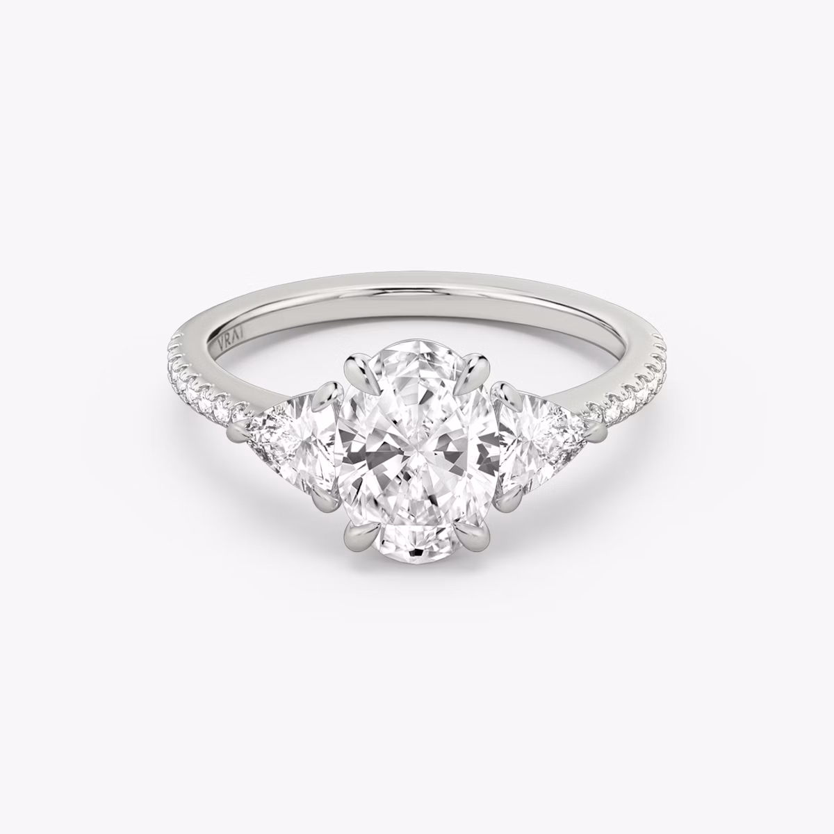 The Three Stone | Oval | Platinum | bandAccent: Pavé | sideStoneCarat: 0.25ct | sideStoneShape: Trillion | diamondOrientation: vertical | caratWeight: other