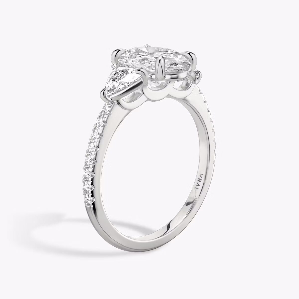 The Three Stone | Oval | Platinum | bandAccent: Pavé | sideStoneCarat: 0.25ct | sideStoneShape: Trillion | diamondOrientation: vertical | caratWeight: other