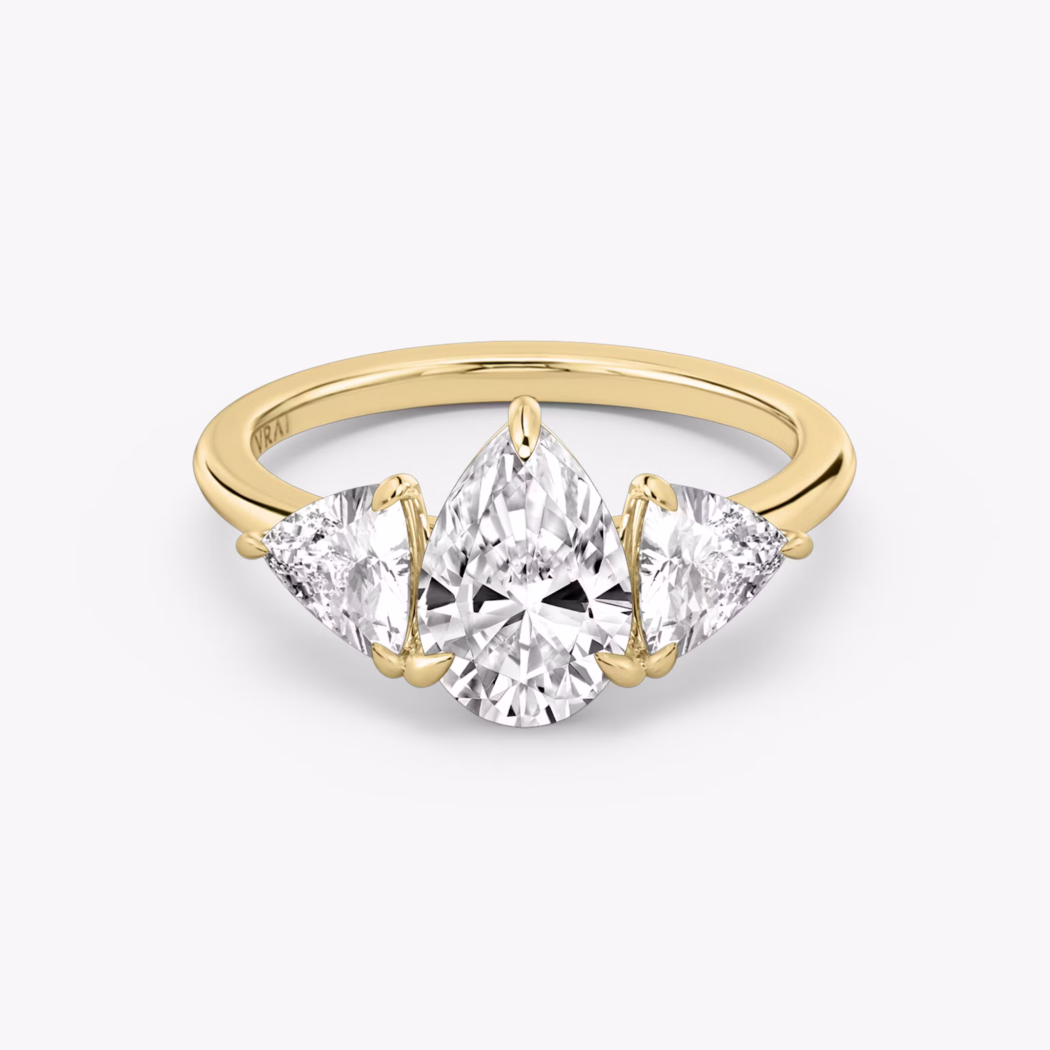 The Three Stone | Pear | 18k | Yellow Gold | bandAccent: Plain | sideStoneCarat: 0.50ct | sideStoneShape: Trillion | diamondOrientation: vertical | caratWeight: other
