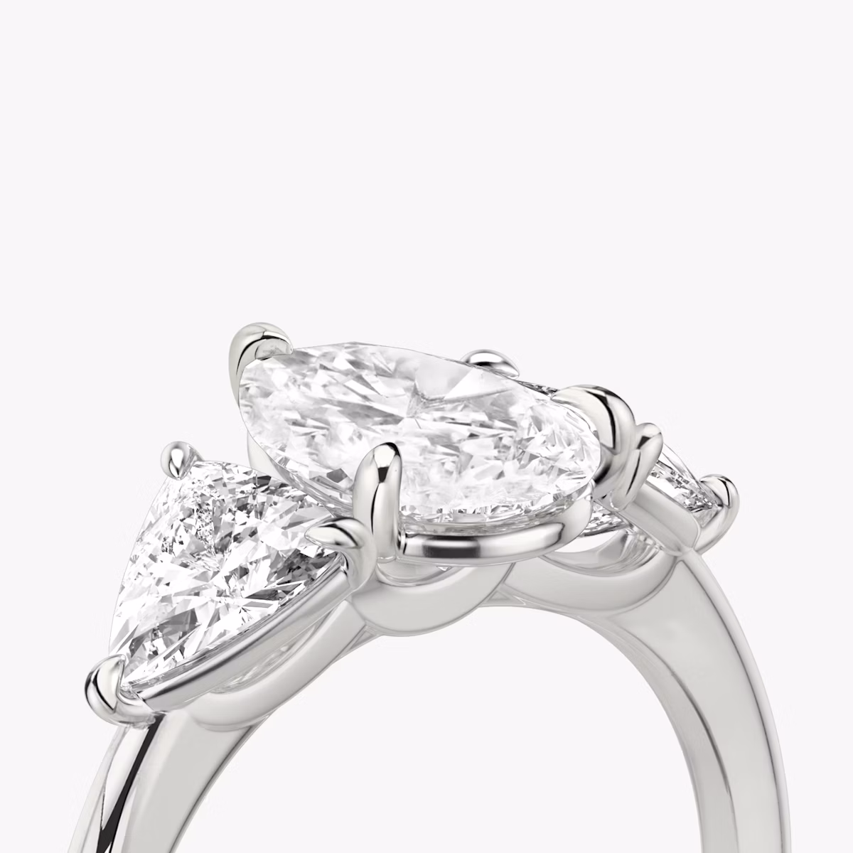 The Three Stone | Pear | Platinum | bandAccent: Plain | sideStoneCarat: 0.50ct | sideStoneShape: Trillion | diamondOrientation: vertical | caratWeight: other