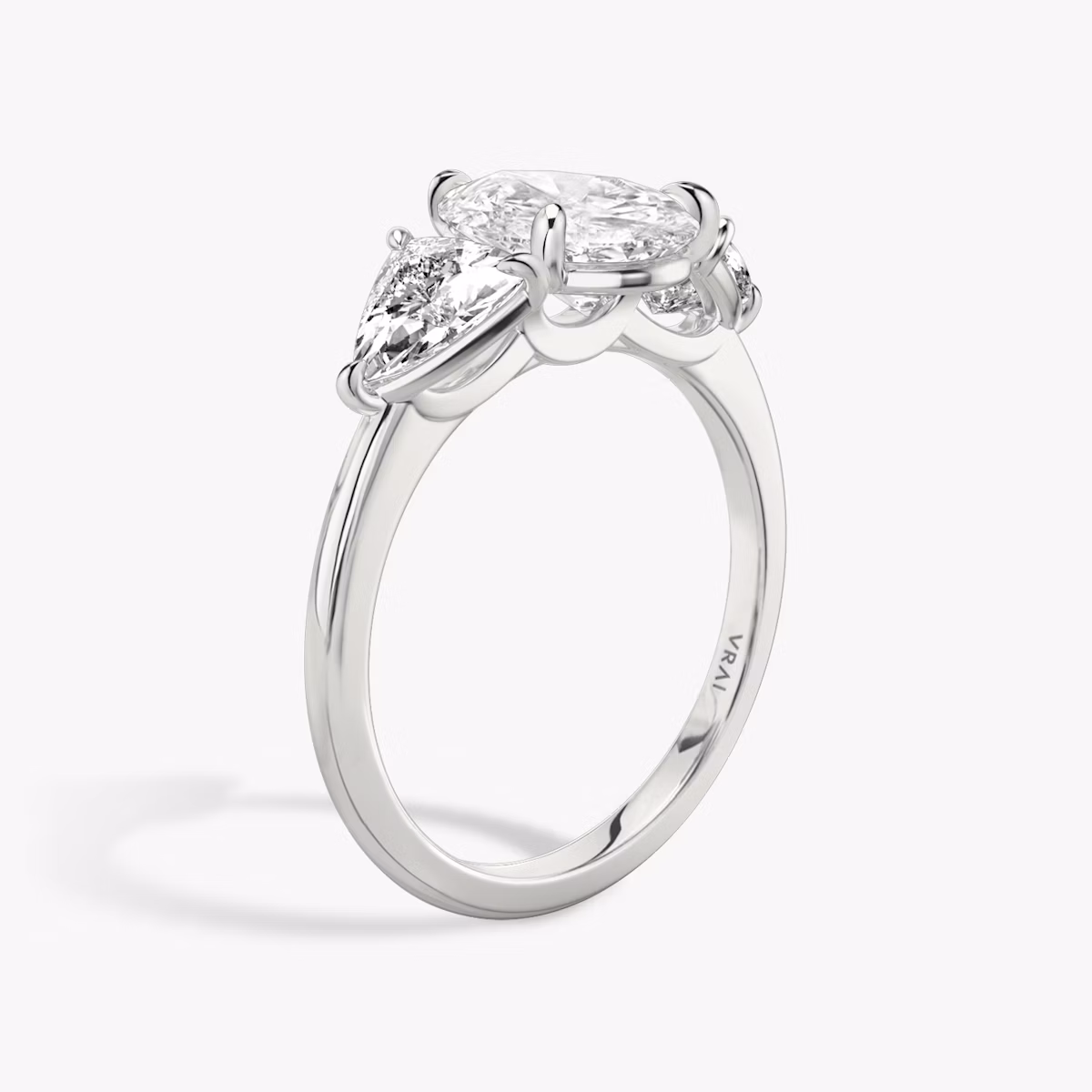 The Three Stone | Pear | Platinum | bandAccent: Plain | sideStoneCarat: 0.50ct | sideStoneShape: Trillion | diamondOrientation: vertical | caratWeight: other