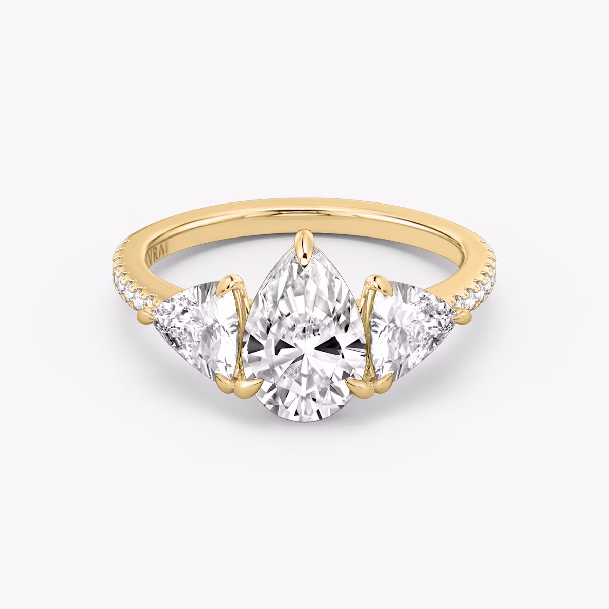 The Three Stone | Pear | 18k | Yellow Gold | bandAccent: Pavé | sideStoneCarat: 0.50ct | sideStoneShape: Trillion | diamondOrientation: vertical | caratWeight: other