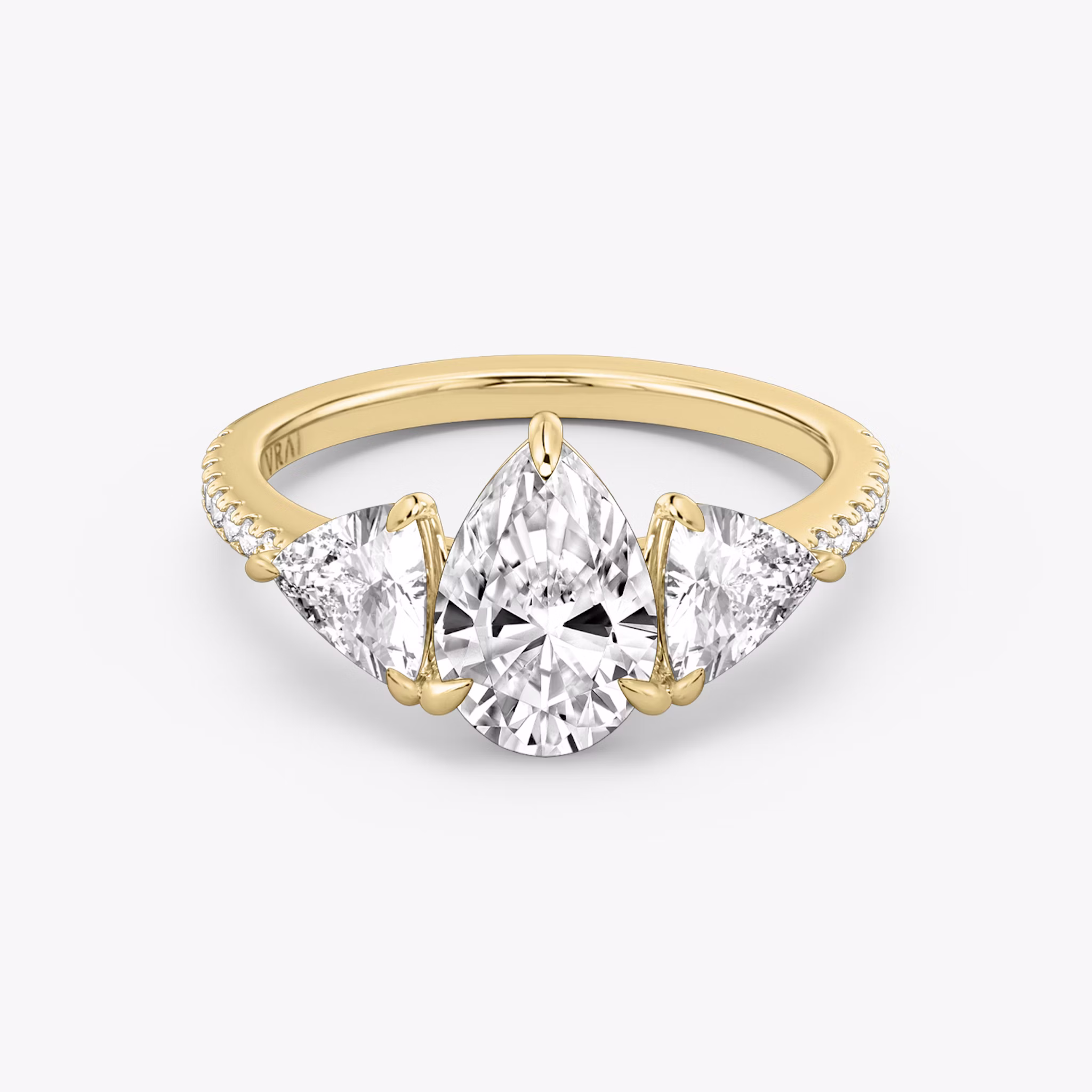 The Three Stone | Pear | 18k | Yellow Gold | bandAccent: Pavé | sideStoneCarat: 0.50ct | sideStoneShape: Trillion | diamondOrientation: vertical | caratWeight: other