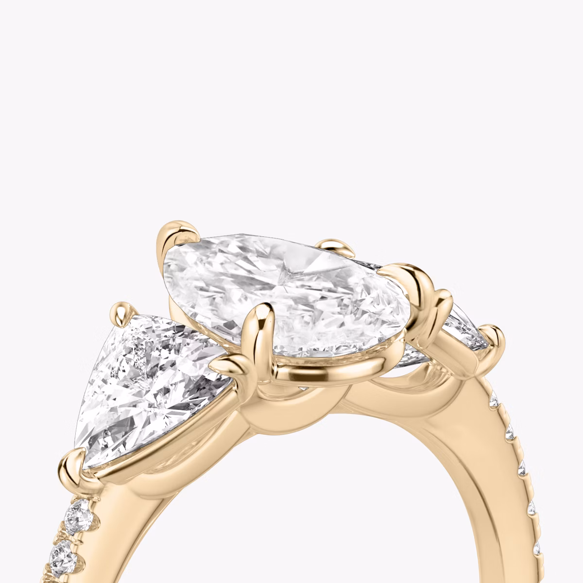 The Three Stone | Pear | 14k | Rose Gold | bandAccent: Pavé | sideStoneCarat: 0.50ct | sideStoneShape: Trillion | diamondOrientation: vertical | caratWeight: other