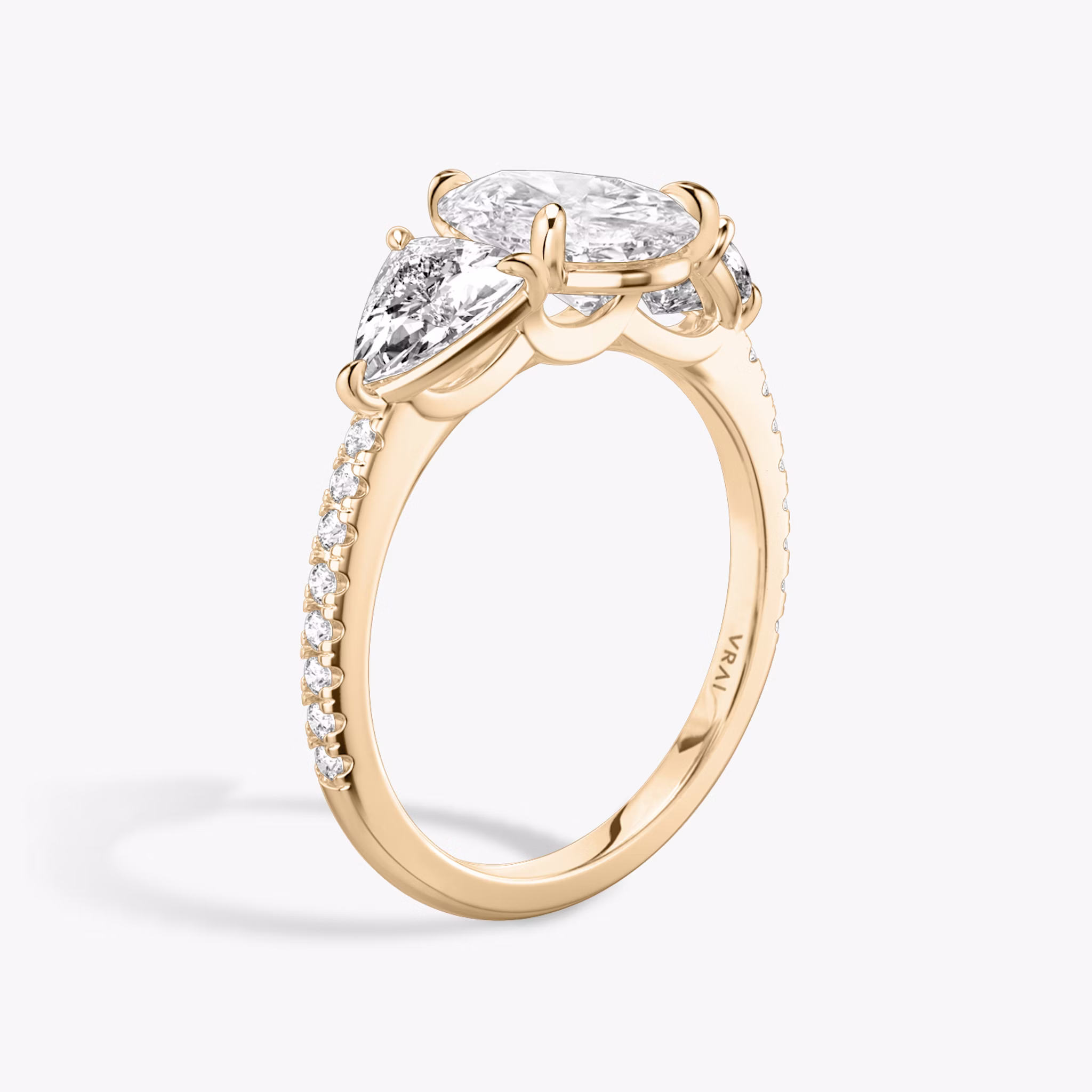 The Three Stone | Pear | 14k | Rose Gold | bandAccent: Pavé | sideStoneCarat: 0.50ct | sideStoneShape: Trillion | diamondOrientation: vertical | caratWeight: other
