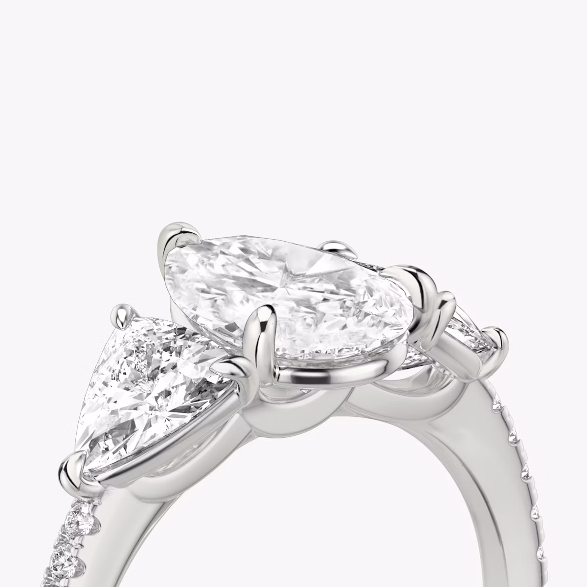 The Three Stone | Pear | Platinum | bandAccent: Pavé | sideStoneCarat: 0.50ct | sideStoneShape: Trillion | diamondOrientation: vertical | caratWeight: other