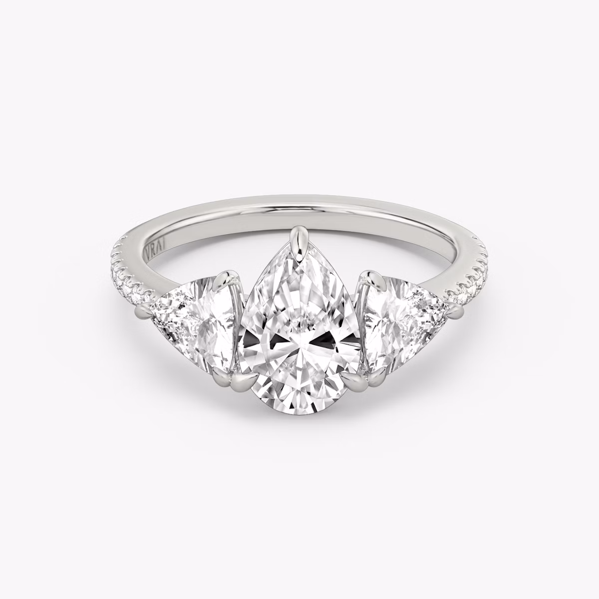 The Three Stone | Pear | Platinum | bandAccent: Pavé | sideStoneCarat: 0.50ct | sideStoneShape: Trillion | diamondOrientation: vertical | caratWeight: other