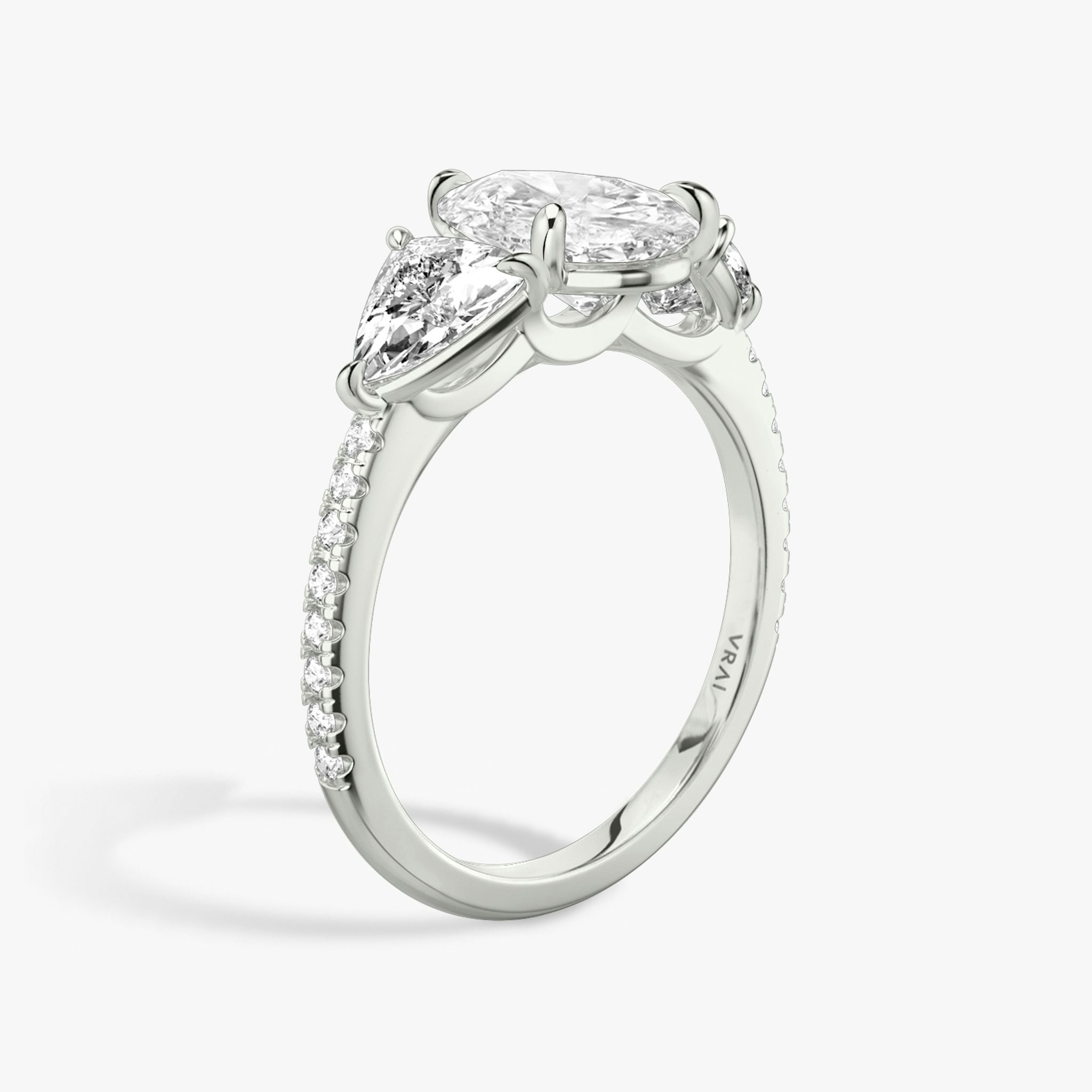 The Three Stone | Pear | Platinum | bandAccent: Pavé | sideStoneCarat: 0.50ct | sideStoneShape: Trillion | diamondOrientation: vertical | caratWeight: other