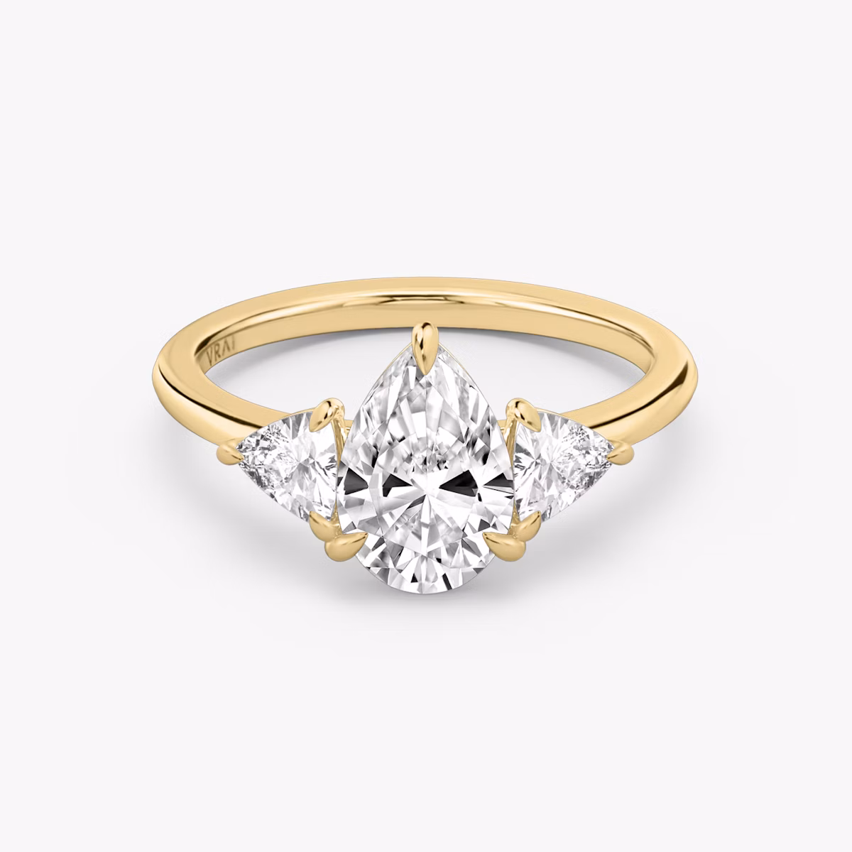 The Three Stone | Pear | 18k | Yellow Gold | bandAccent: Plain | sideStoneCarat: 0.25ct | sideStoneShape: Trillion | diamondOrientation: vertical | caratWeight: other