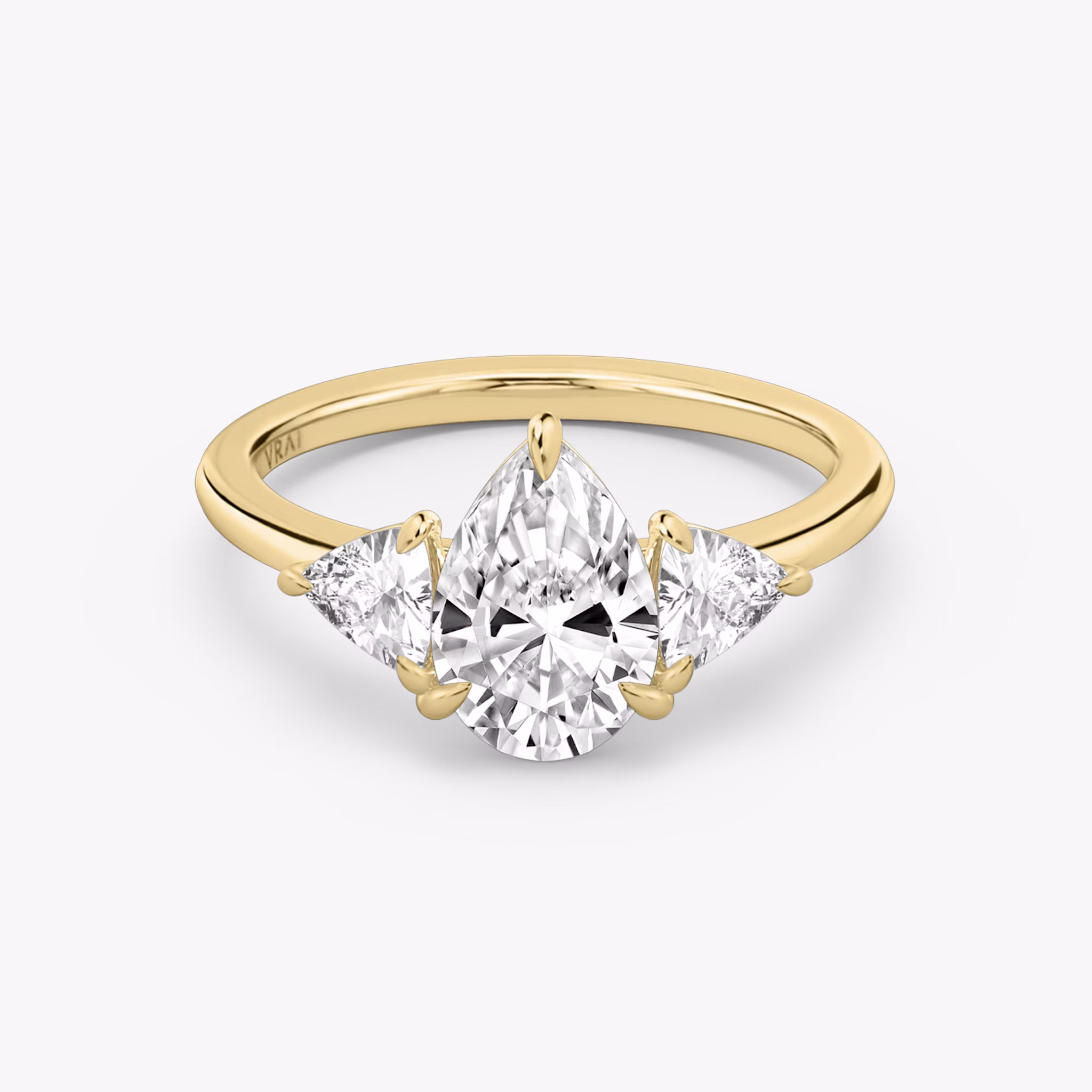 The Three Stone | Pear | 18k | Yellow Gold | bandAccent: Plain | sideStoneCarat: 0.25ct | sideStoneShape: Trillion | diamondOrientation: vertical | caratWeight: other