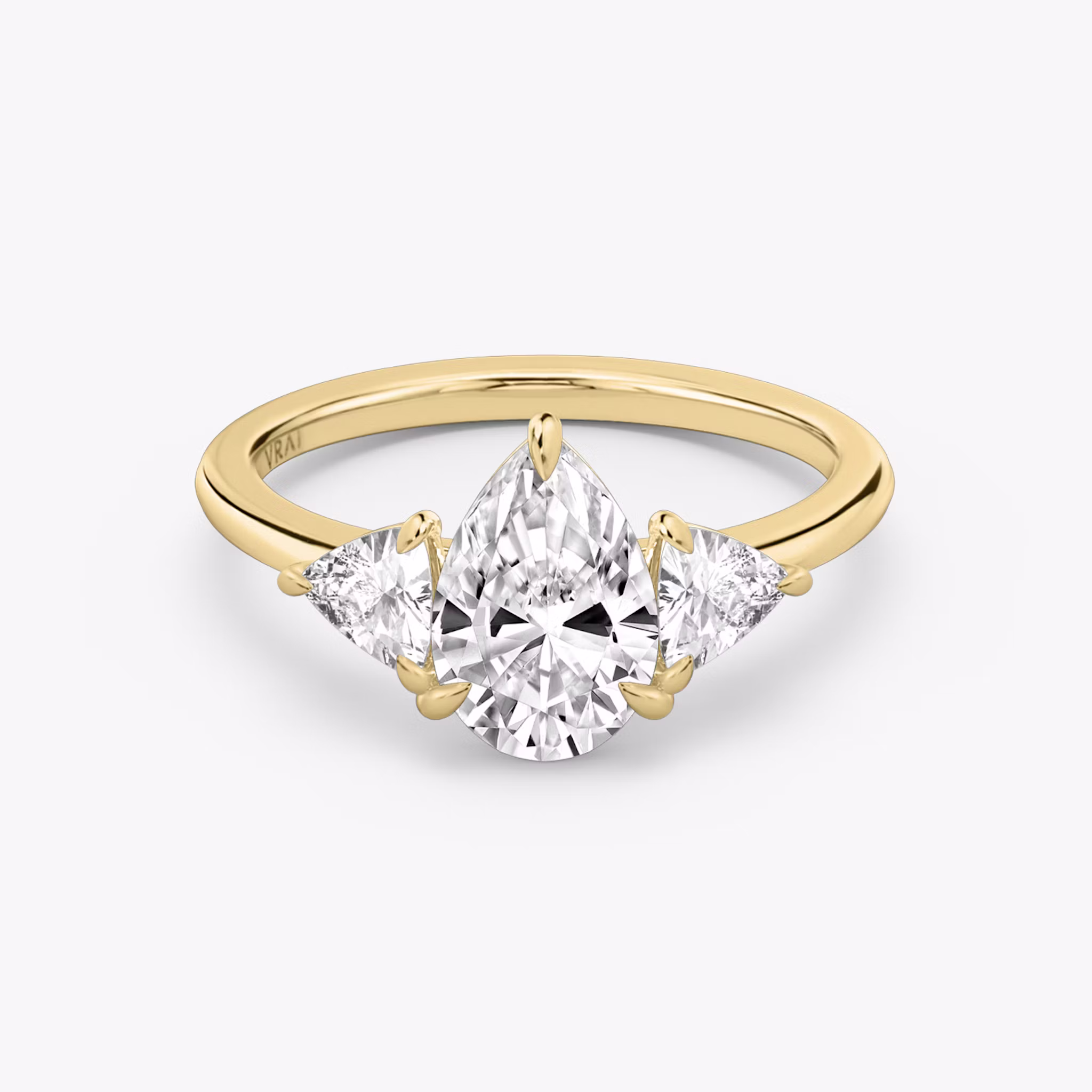 The Three Stone | Pear | 18k | Yellow Gold | bandAccent: Plain | sideStoneCarat: 0.25ct | sideStoneShape: Trillion | diamondOrientation: vertical | caratWeight: other
