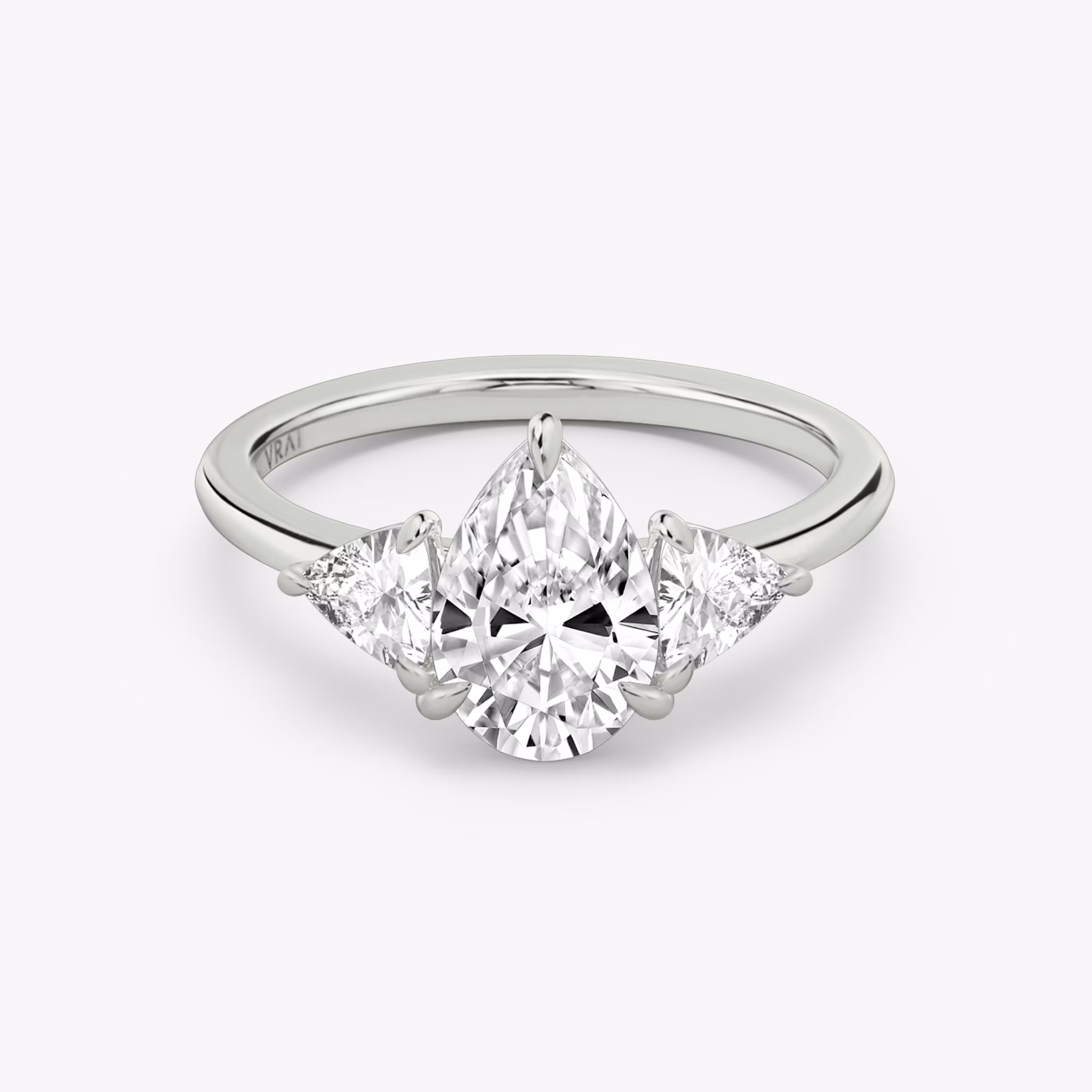 The Three Stone | Pear | 18k | White Gold | bandAccent: Plain | sideStoneCarat: 0.25ct | sideStoneShape: Trillion | diamondOrientation: vertical | caratWeight: other