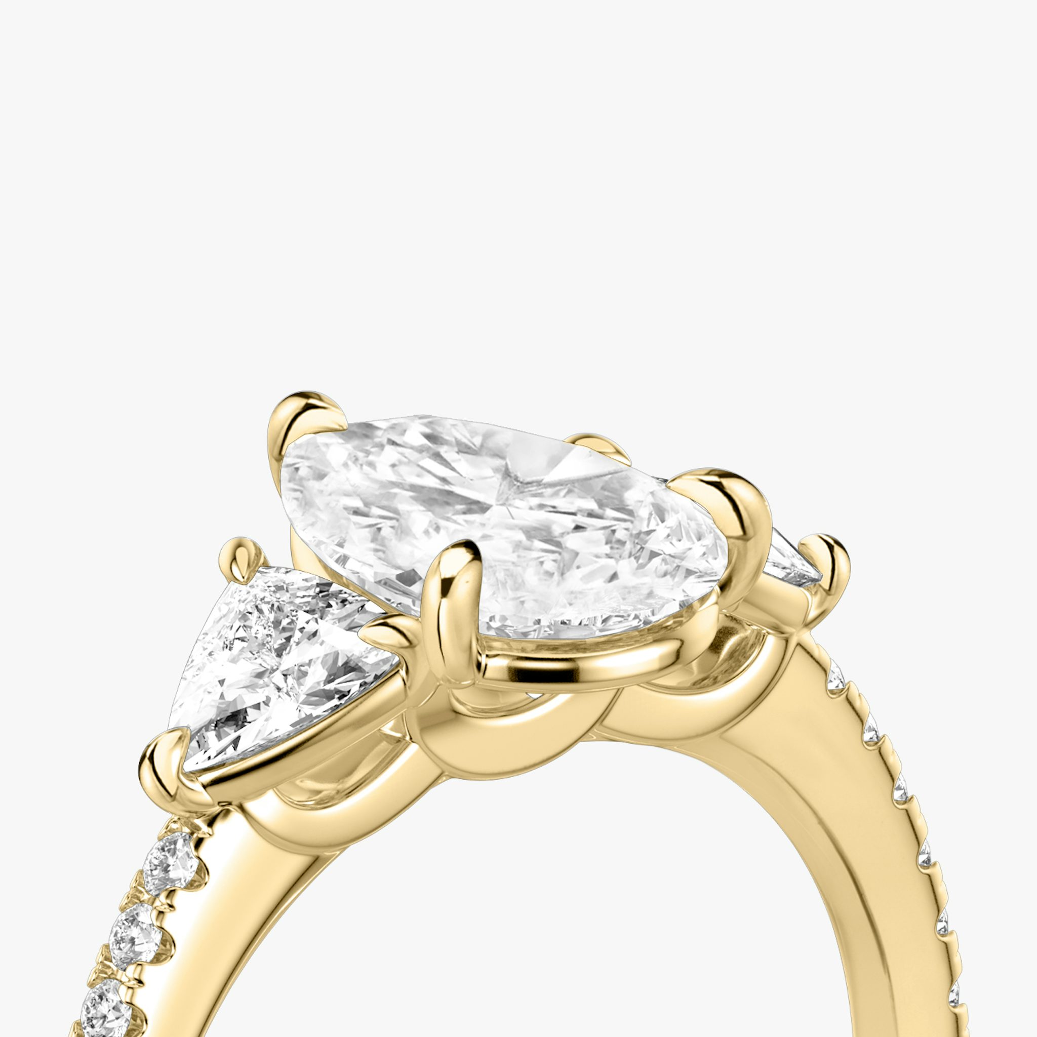 The Three Stone | Pear | 18k | Yellow Gold | bandAccent: Pavé | sideStoneCarat: 0.25ct | sideStoneShape: Trillion | diamondOrientation: vertical | caratWeight: other