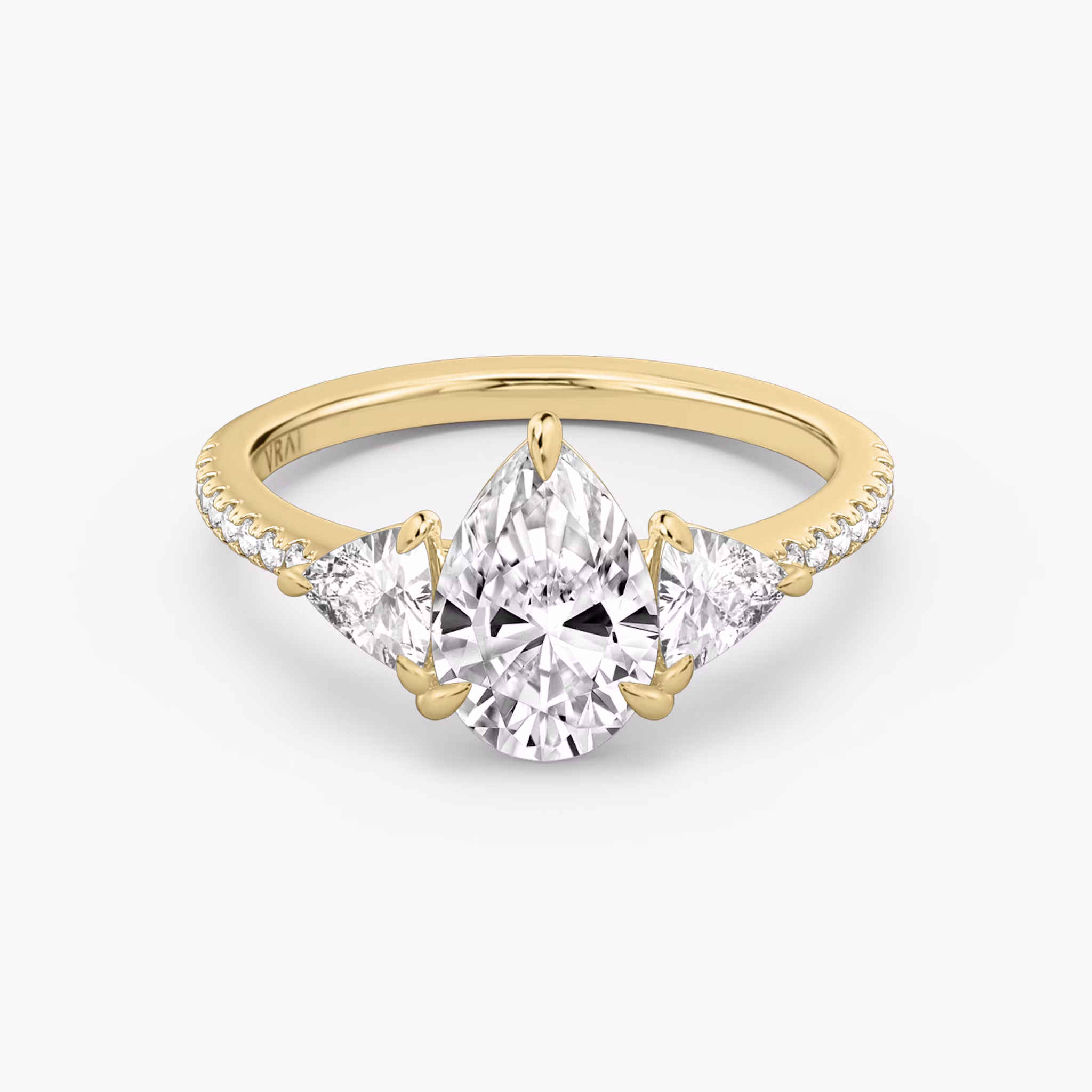 The Three Stone | Pear | 18k | Yellow Gold | bandAccent: Pavé | sideStoneCarat: 0.25ct | sideStoneShape: Trillion | diamondOrientation: vertical | caratWeight: other