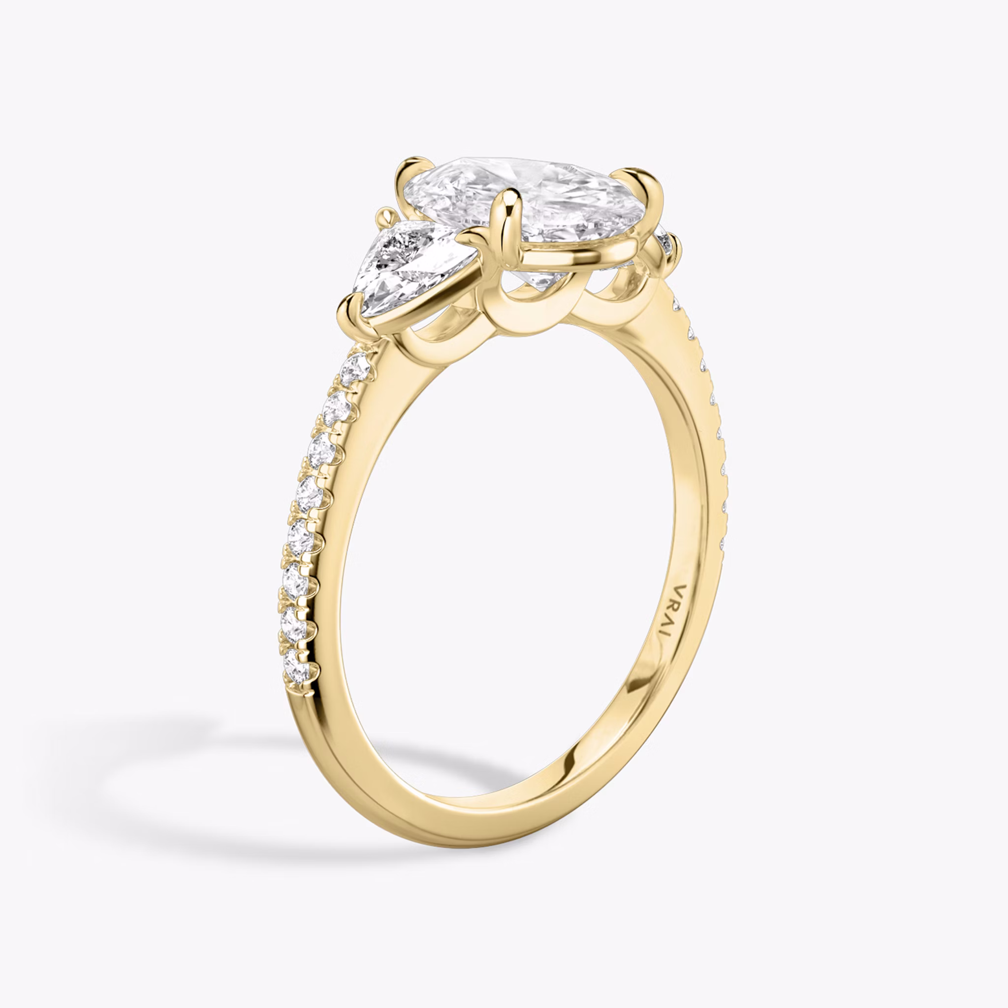 The Three Stone | Pear | 18k | Yellow Gold | bandAccent: Pavé | sideStoneCarat: 0.25ct | sideStoneShape: Trillion | diamondOrientation: vertical | caratWeight: other