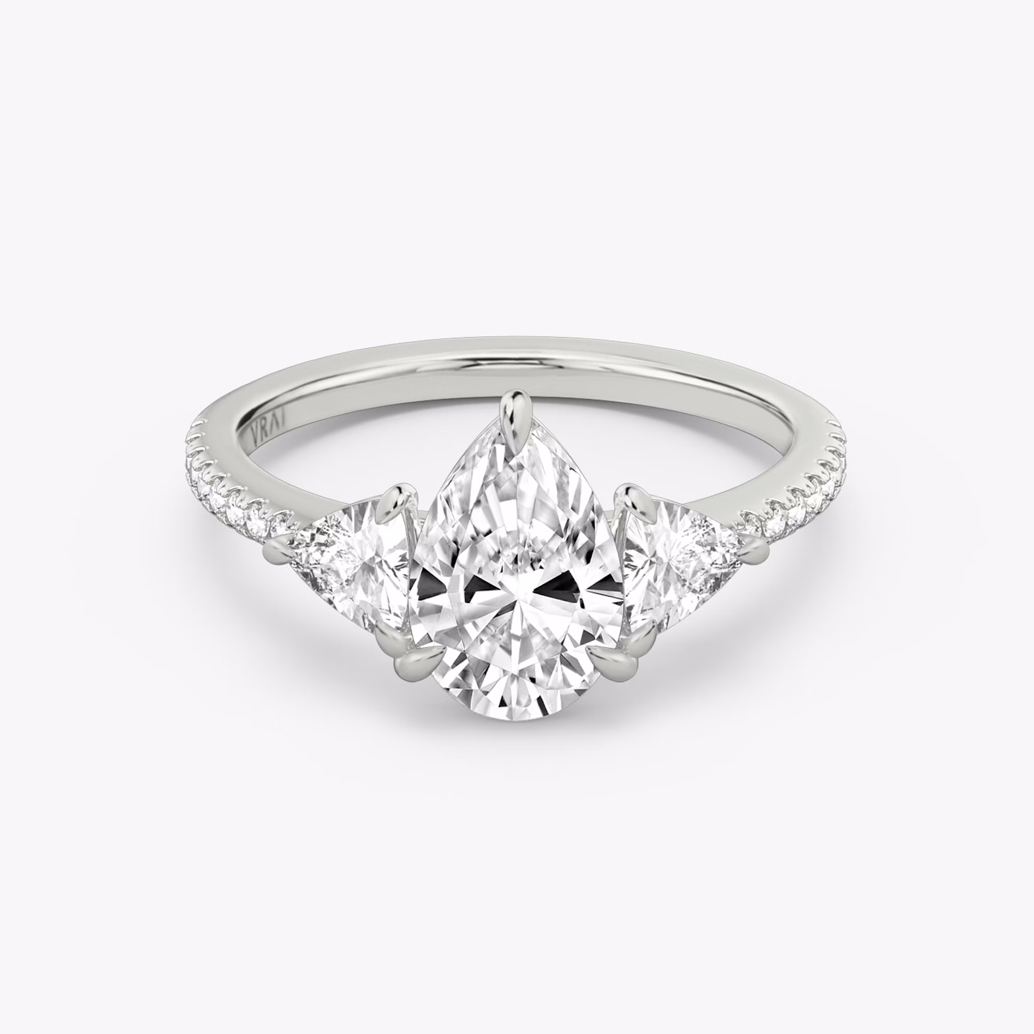 The Three Stone | Pear | 18k | White Gold | bandAccent: Pavé | sideStoneCarat: 0.25ct | sideStoneShape: Trillion | diamondOrientation: vertical | caratWeight: other