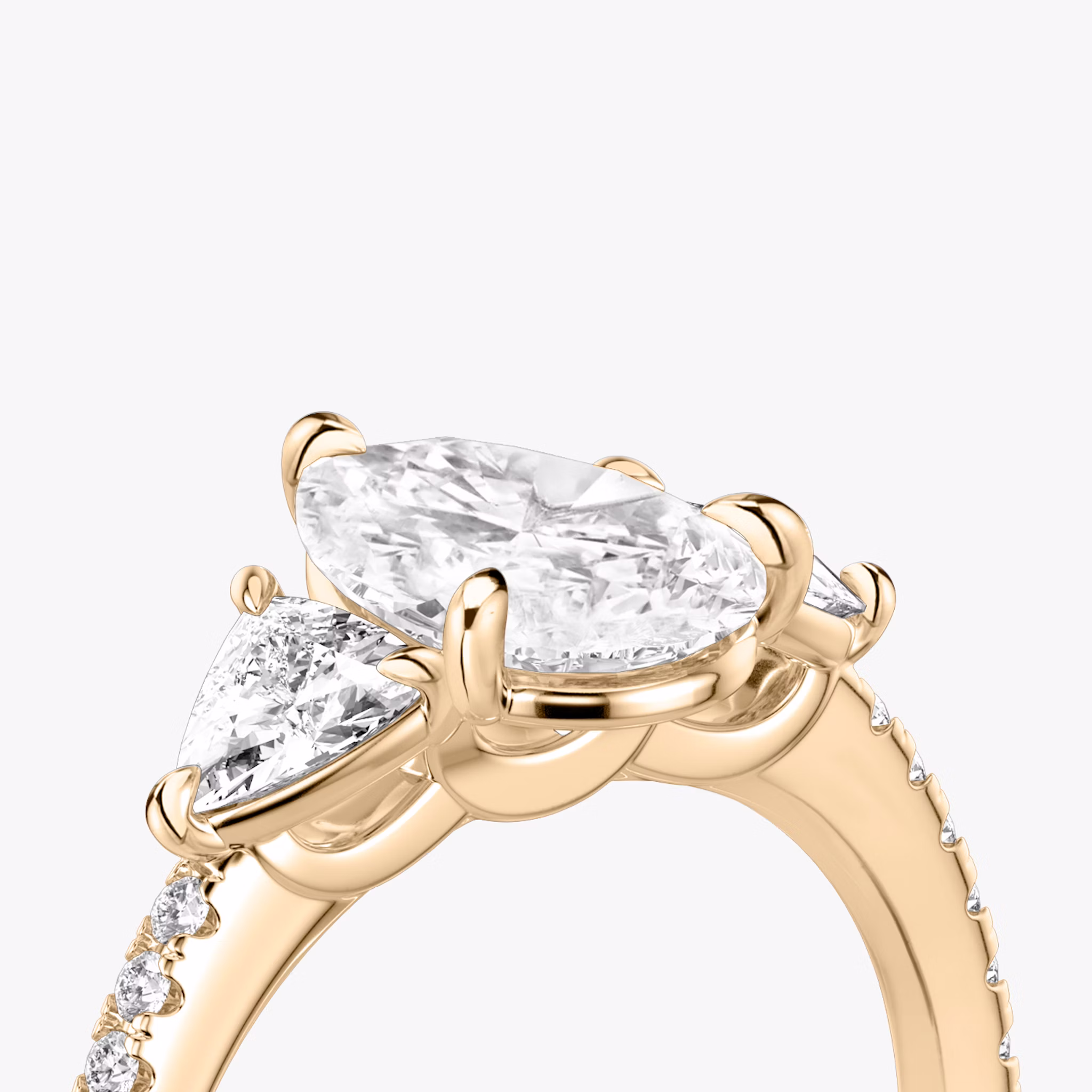 The Three Stone | Pear | 14k | Rose Gold | bandAccent: Pavé | sideStoneCarat: 0.25ct | sideStoneShape: Trillion | diamondOrientation: vertical | caratWeight: other